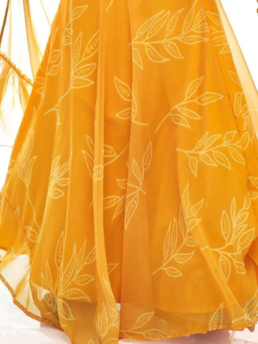 Mustard yellow ethnic gown with white leaf print, lightweight fabric, perfect for Indian occasions