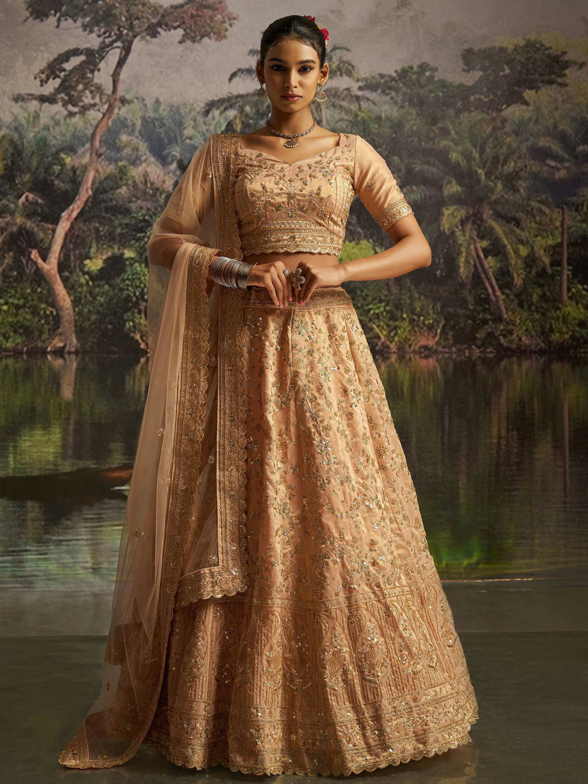 Elegant peach lehenga choli with gold embroidery, perfect for Indian weddings and festive occasions.