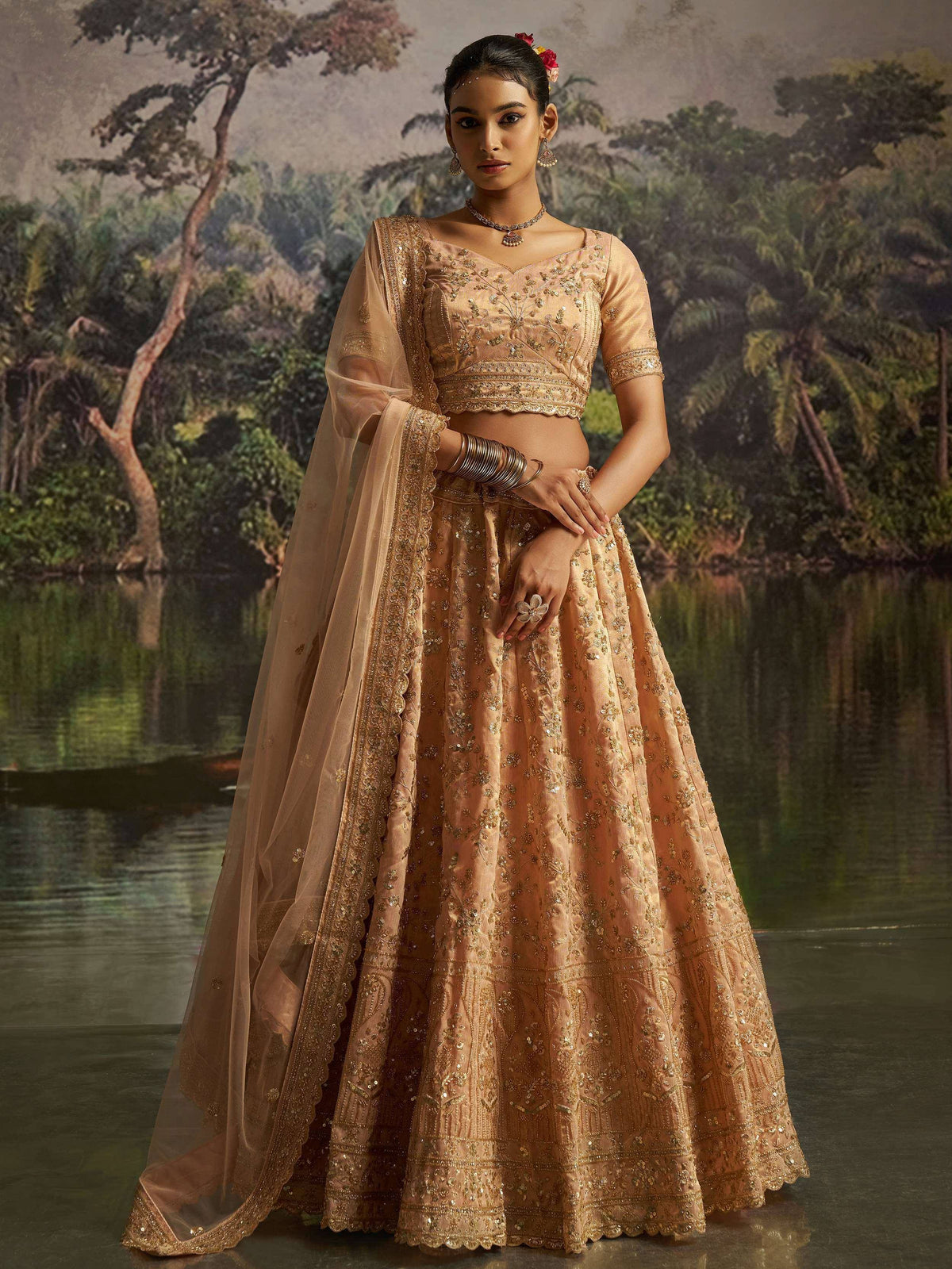 Elegant peach lehenga choli with gold embroidery, perfect for Indian weddings and festive occasions.
