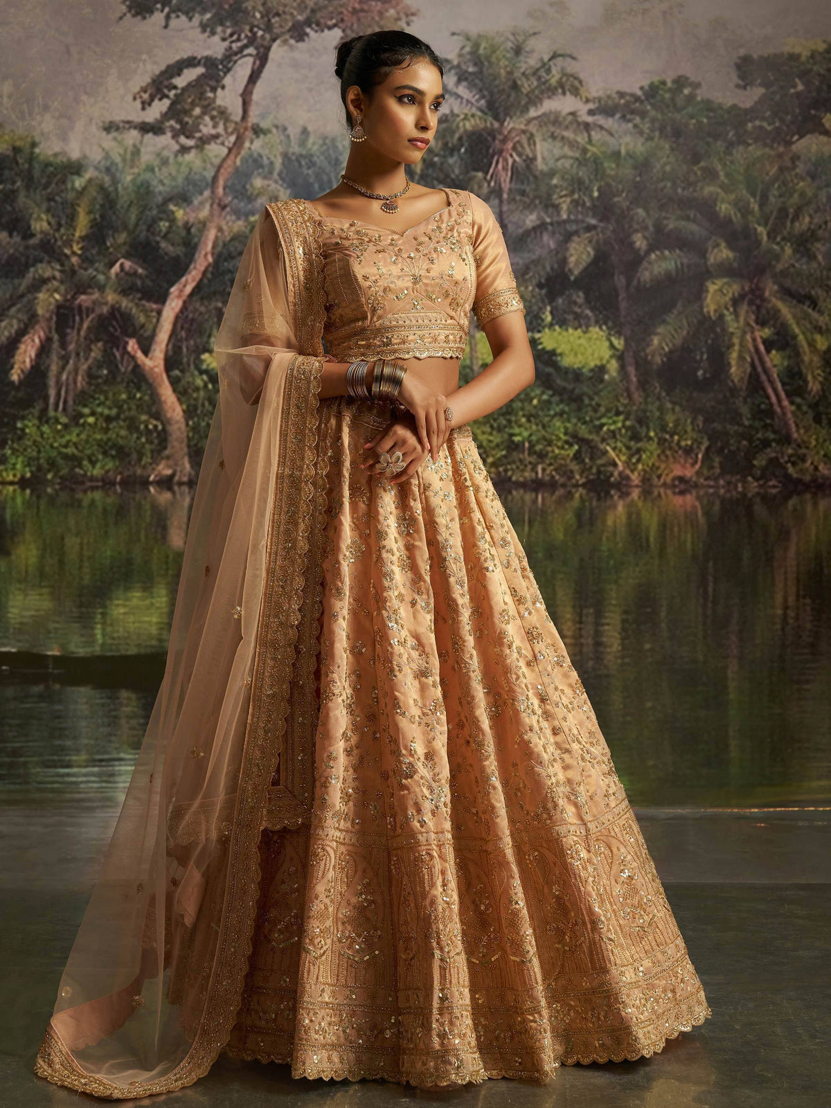 Elegant peach lehenga choli with gold embroidery, perfect for Indian weddings and festive occasions.