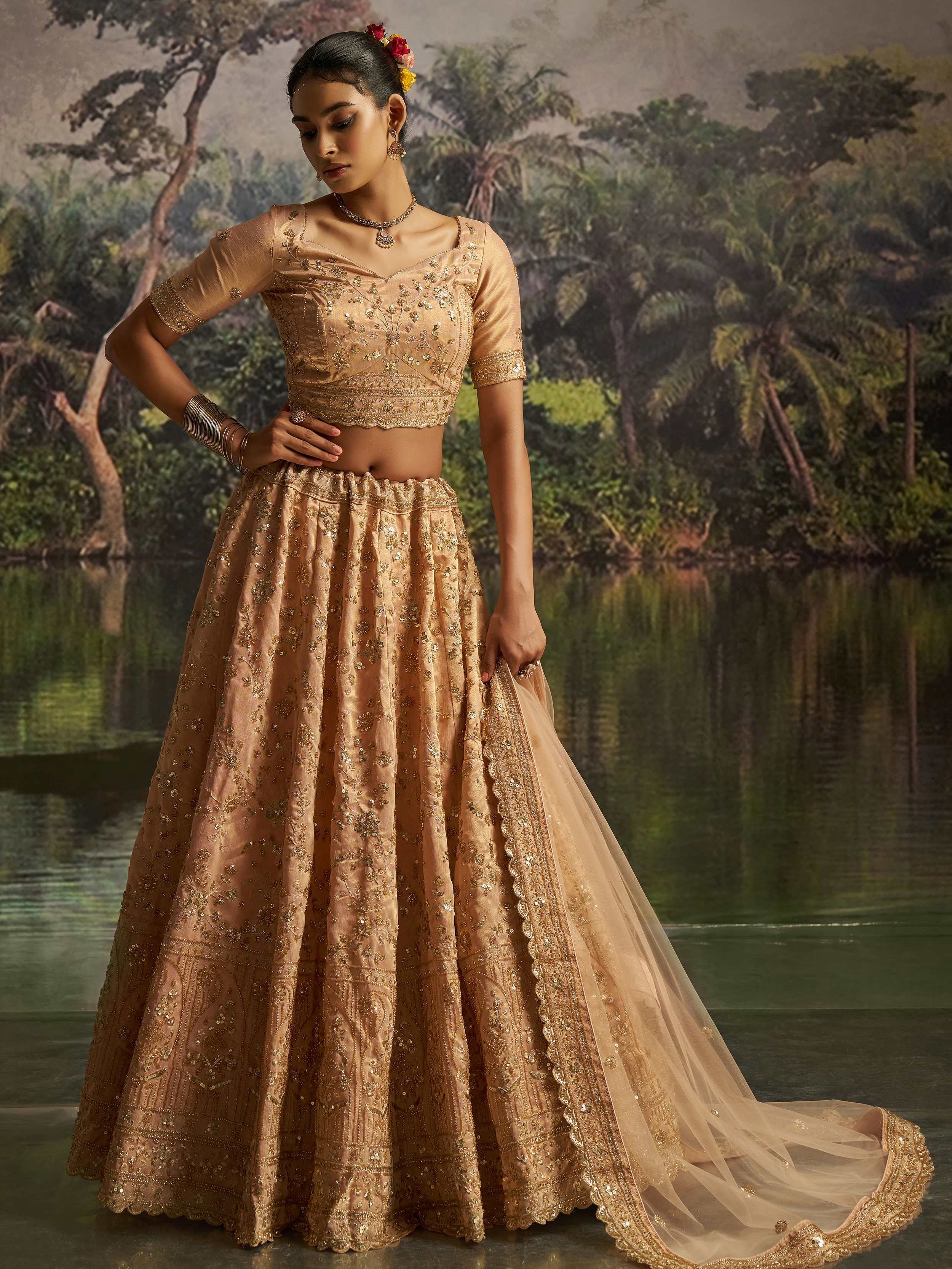 Tantalizing Peach Net Sequins Embroidered Traditional Lehenga Choli