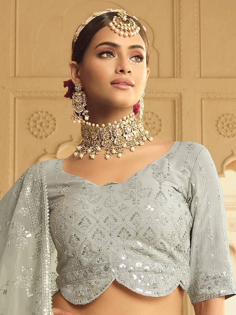 Elegant silver sequin lehenga choli with heavy jewelry, perfect for Indian ethnic wear events