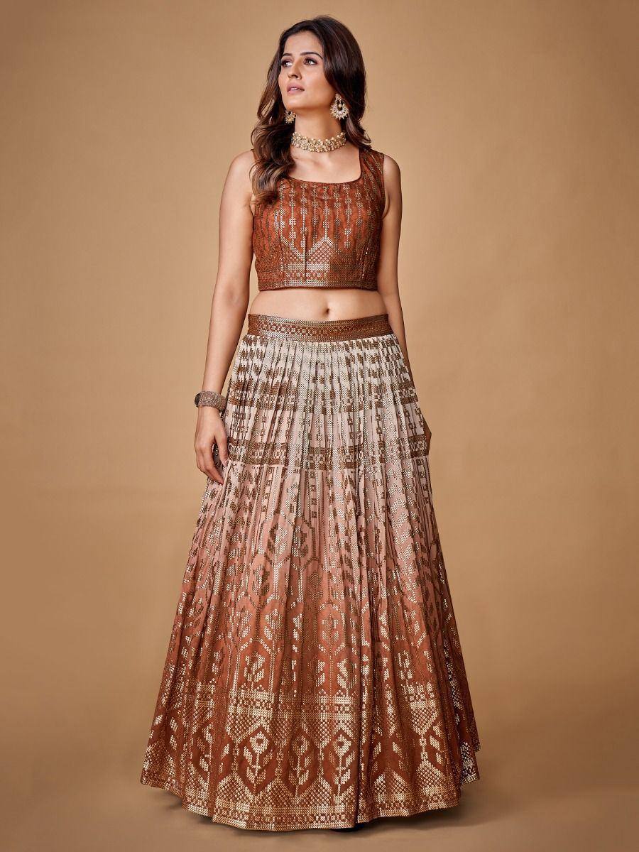 Elegant brown and gold embroidered lehenga choli with geometric patterns, perfect for Indian ethnic occasions.
