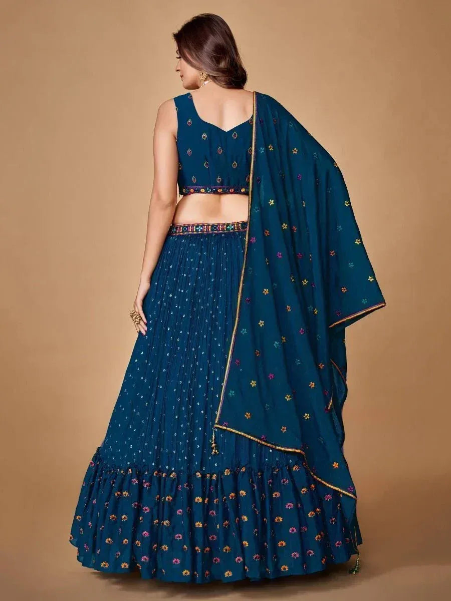 Teal blue embroidered lehenga choli with floral motifs and gold trim, perfect for Indian ethnic occasions