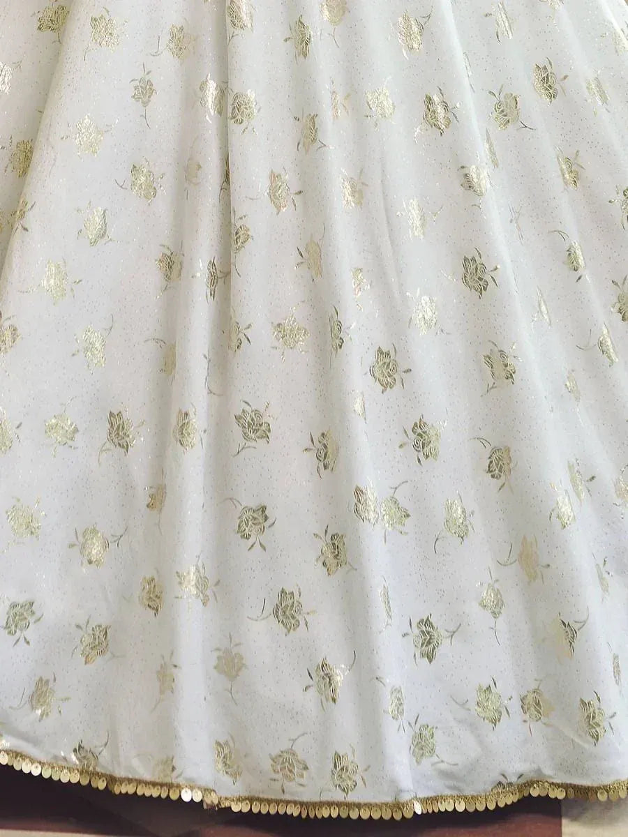 White lehenga with gold floral print and sequin border, ethnic Indian wear