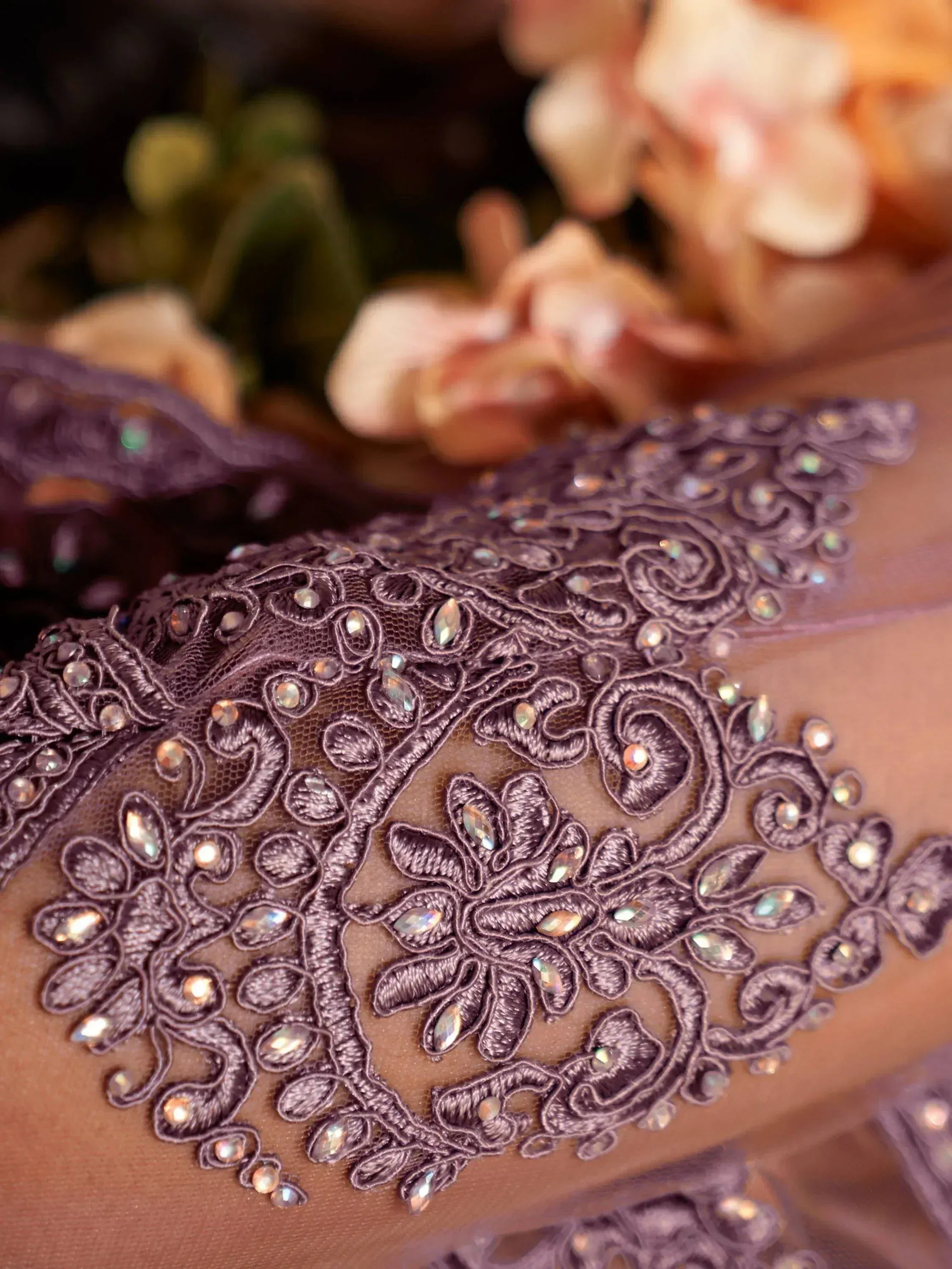 Purple lace ethnic wear with floral embroidery and crystal embellishments, perfect for designer lehenga or saree