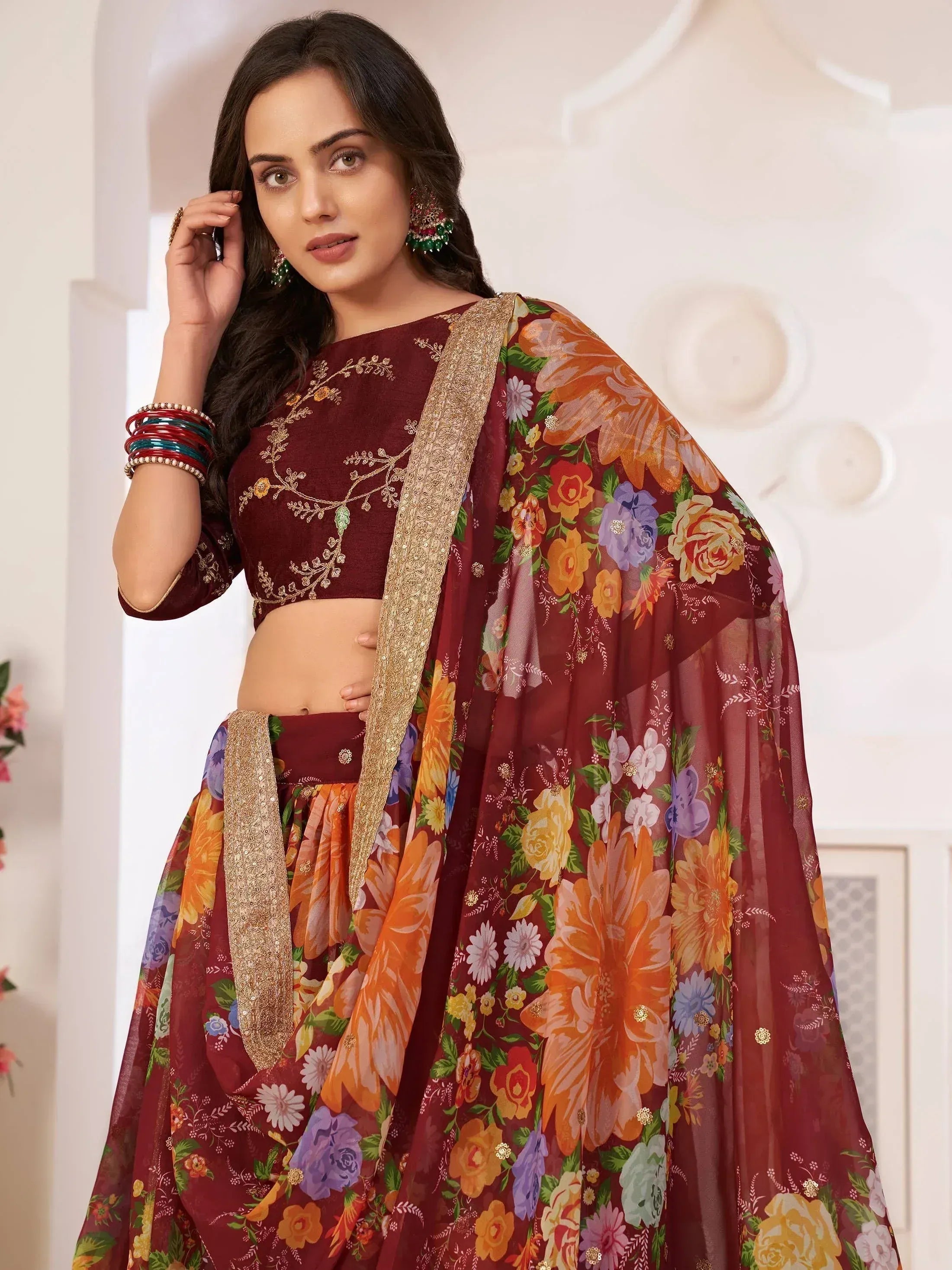 Maroon floral lehenga choli with gold embroidery and sheer dupatta, ethnic Indian wear