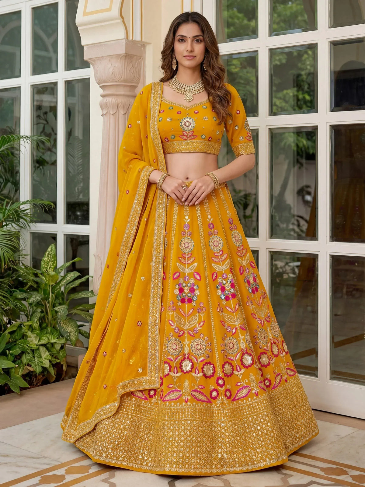 Yellow embroidered lehenga choli with floral motifs, perfect for Indian ethnic wear and festive occasions.
