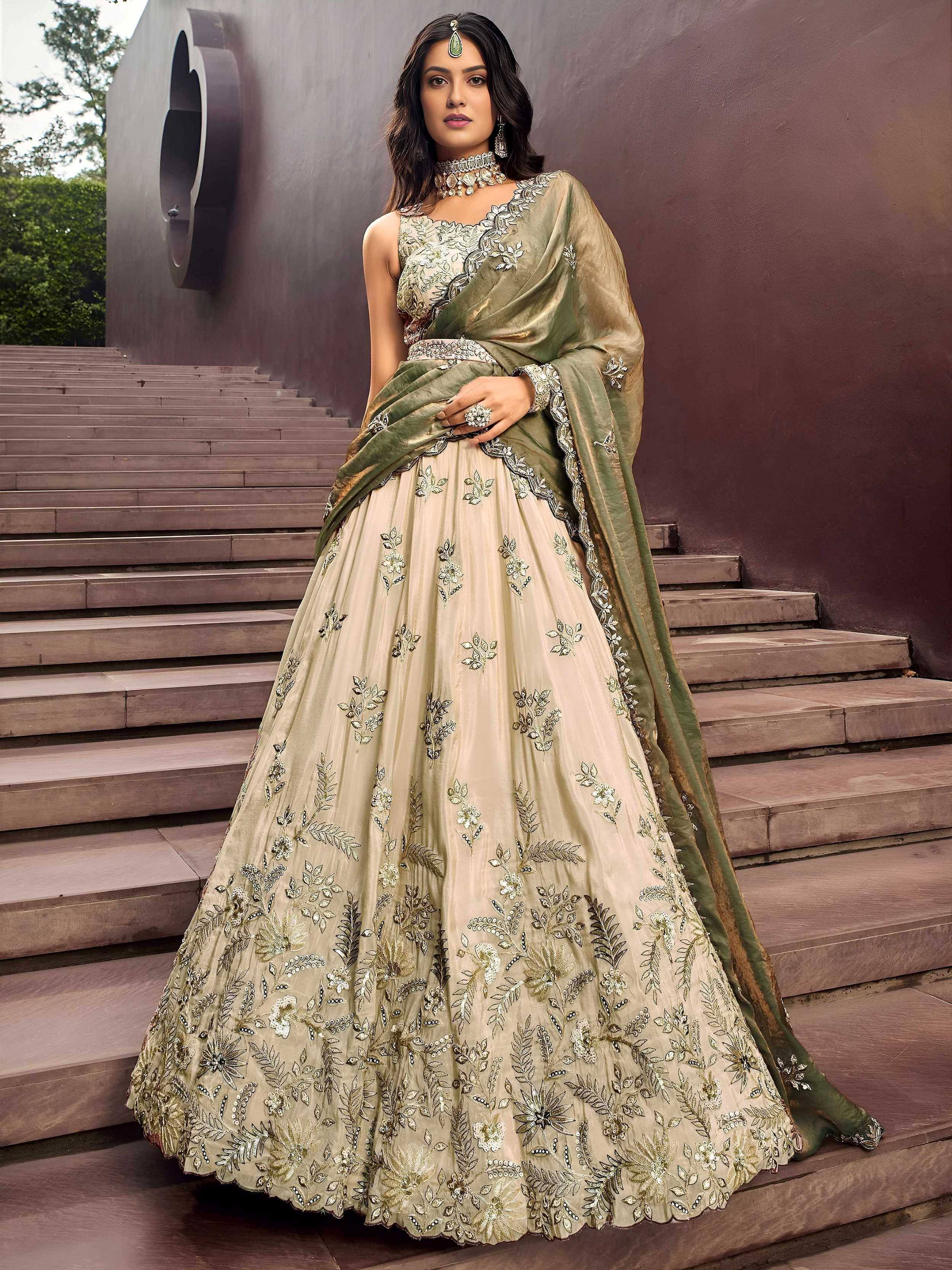 Elegant beige and olive green embroidered lehenga choli with floral motifs, perfect for Indian weddings and festive occasions.
