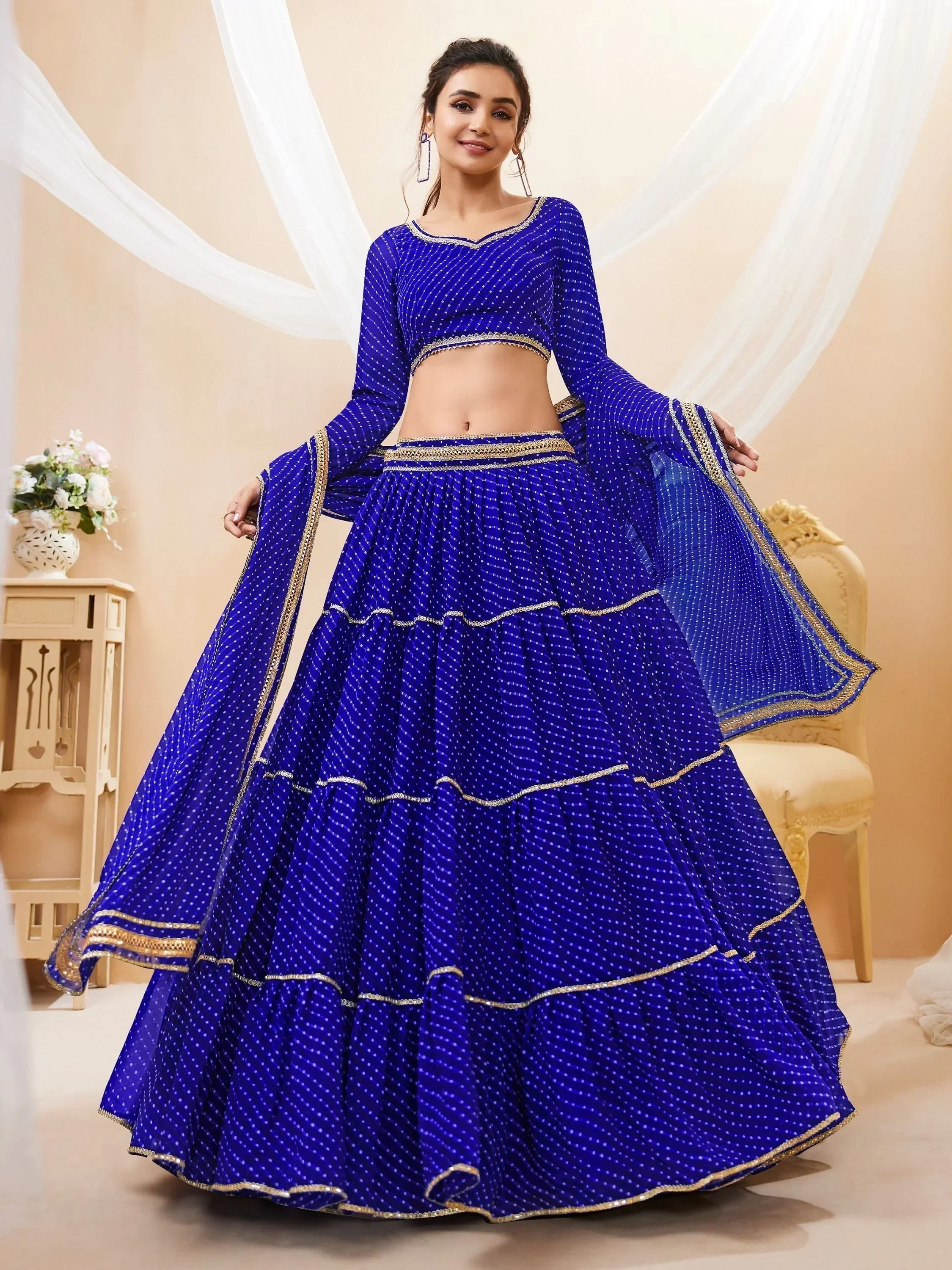 Royal blue designer lehenga choli with gold trim, perfect for Indian ethnic wear and festive occasions.