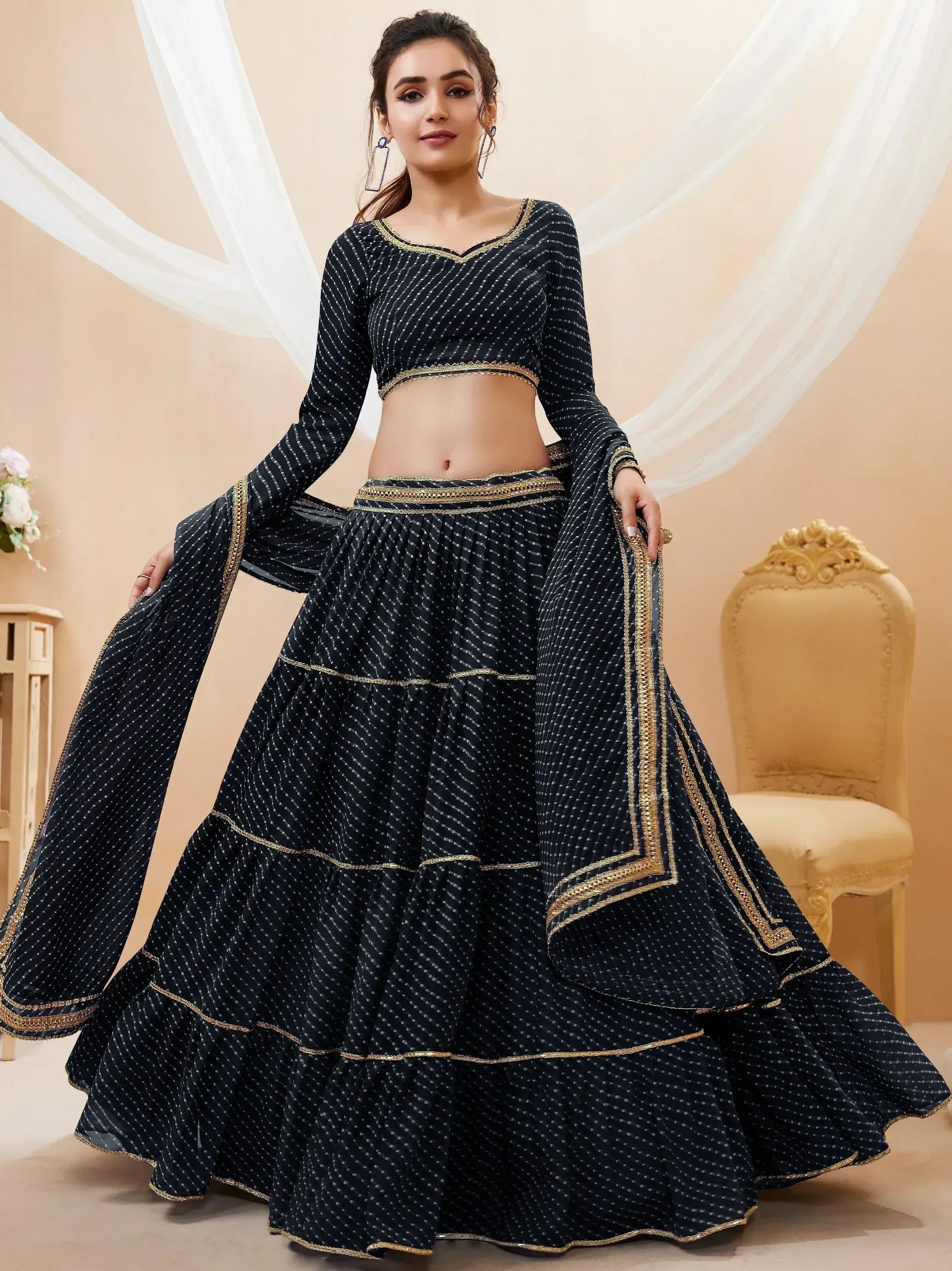 Black printed lehenga choli with gold trim, ethnic Indian wear for women