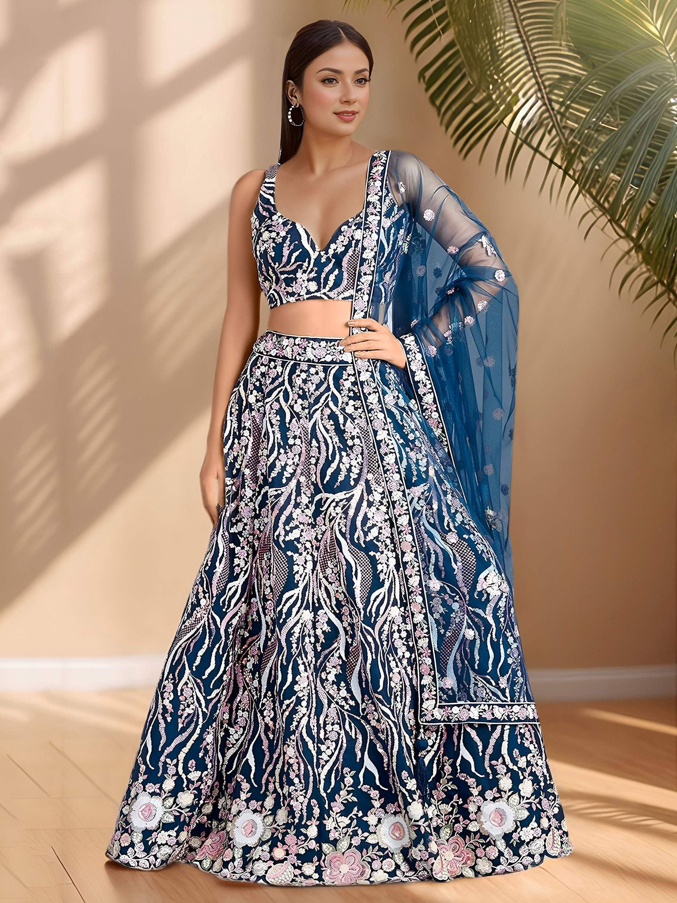 Elegant navy blue lehenga choli with floral embroidery and sheer dupatta, perfect for Indian ethnic occasions.