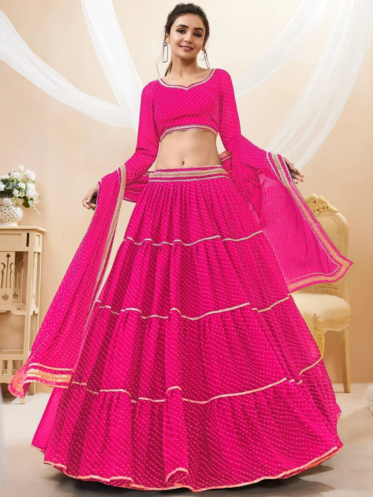 Vibrant pink polka dot lehenga choli with gold trim, perfect for Indian ethnic wear occasions
