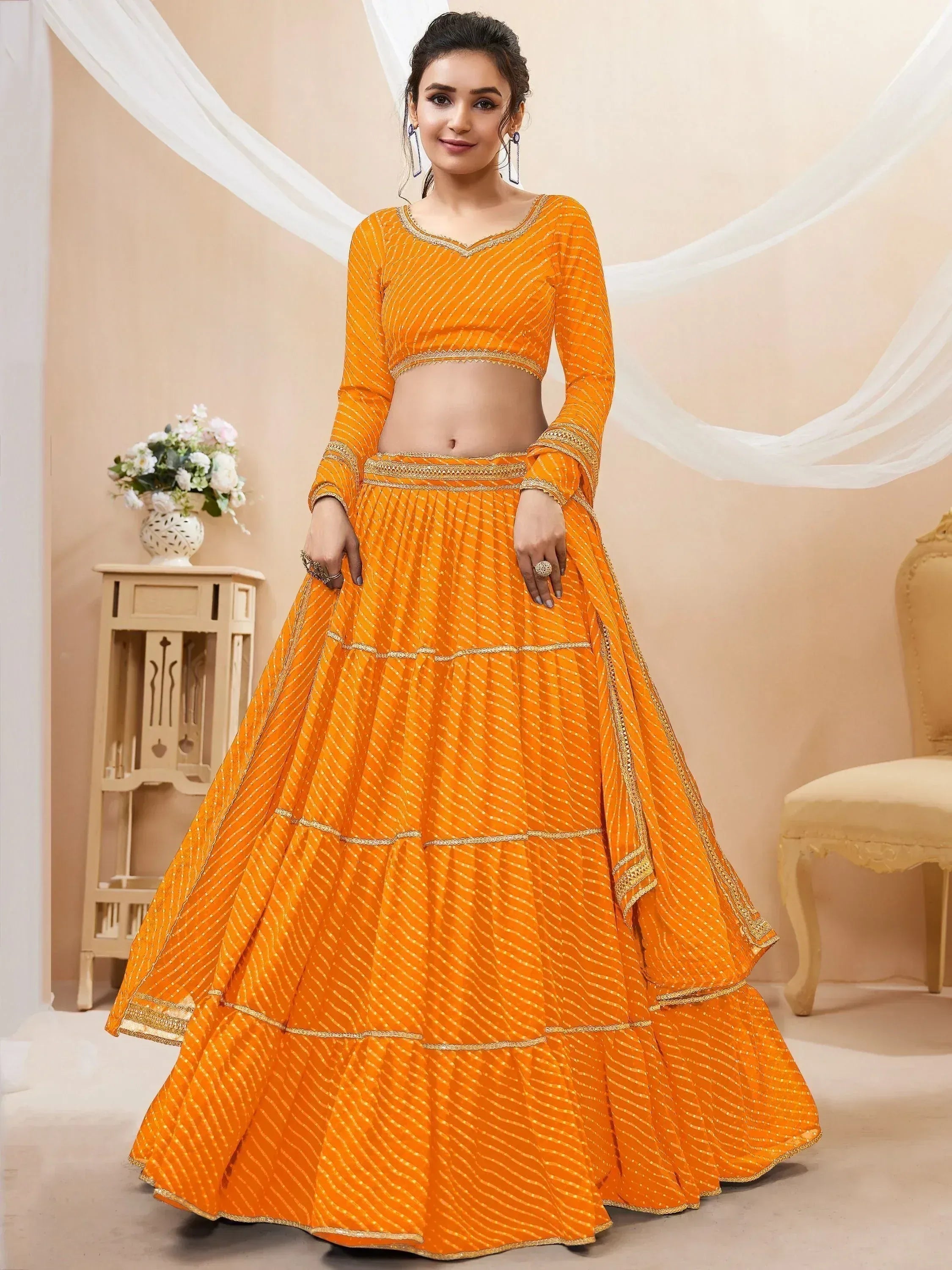 Vibrant orange lehenga choli with gold embroidery, perfect for Indian ethnic occasions and weddings.