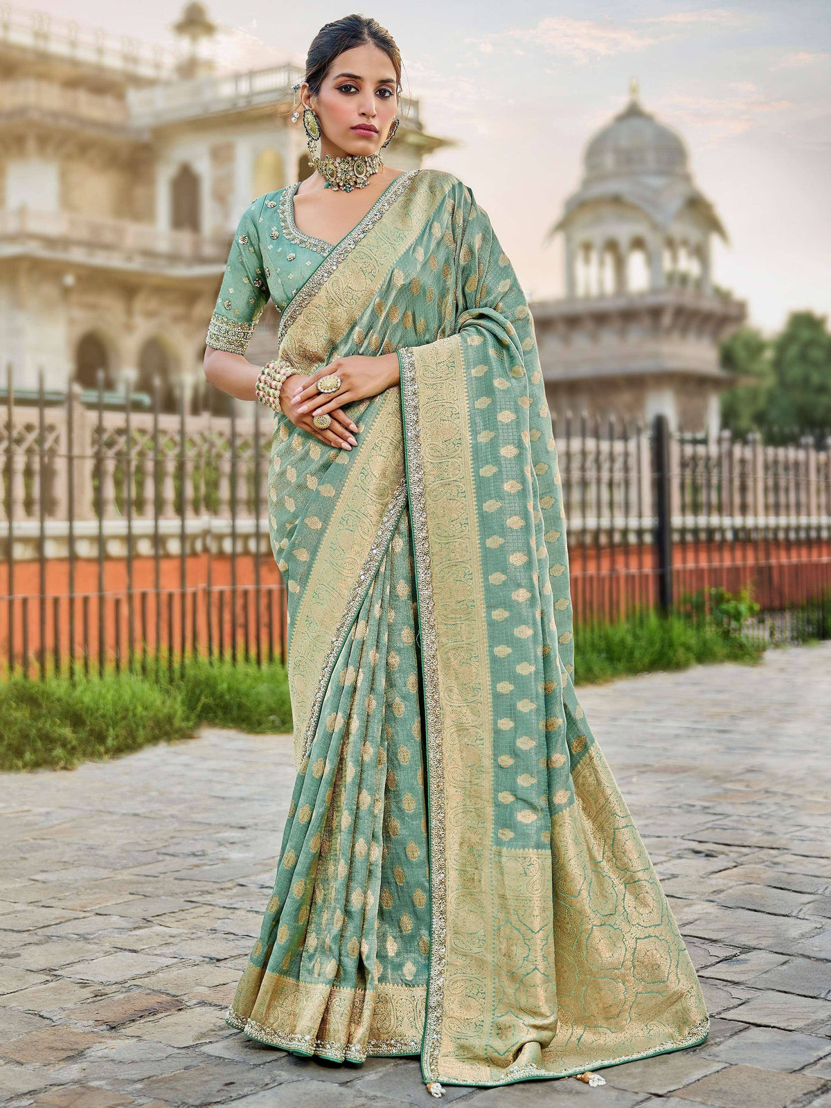 Elegant green and gold designer saree with intricate embroidery, perfect for Indian ethnic wear occasions.