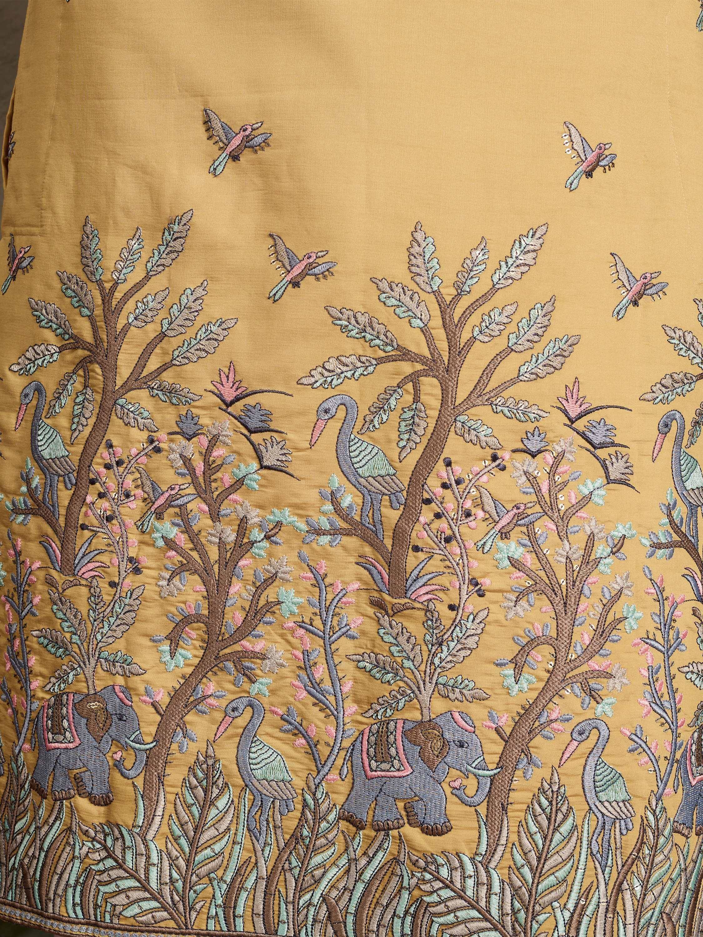 Embroidered ethnic gown with elephant, bird & tree motifs on mustard fabric
