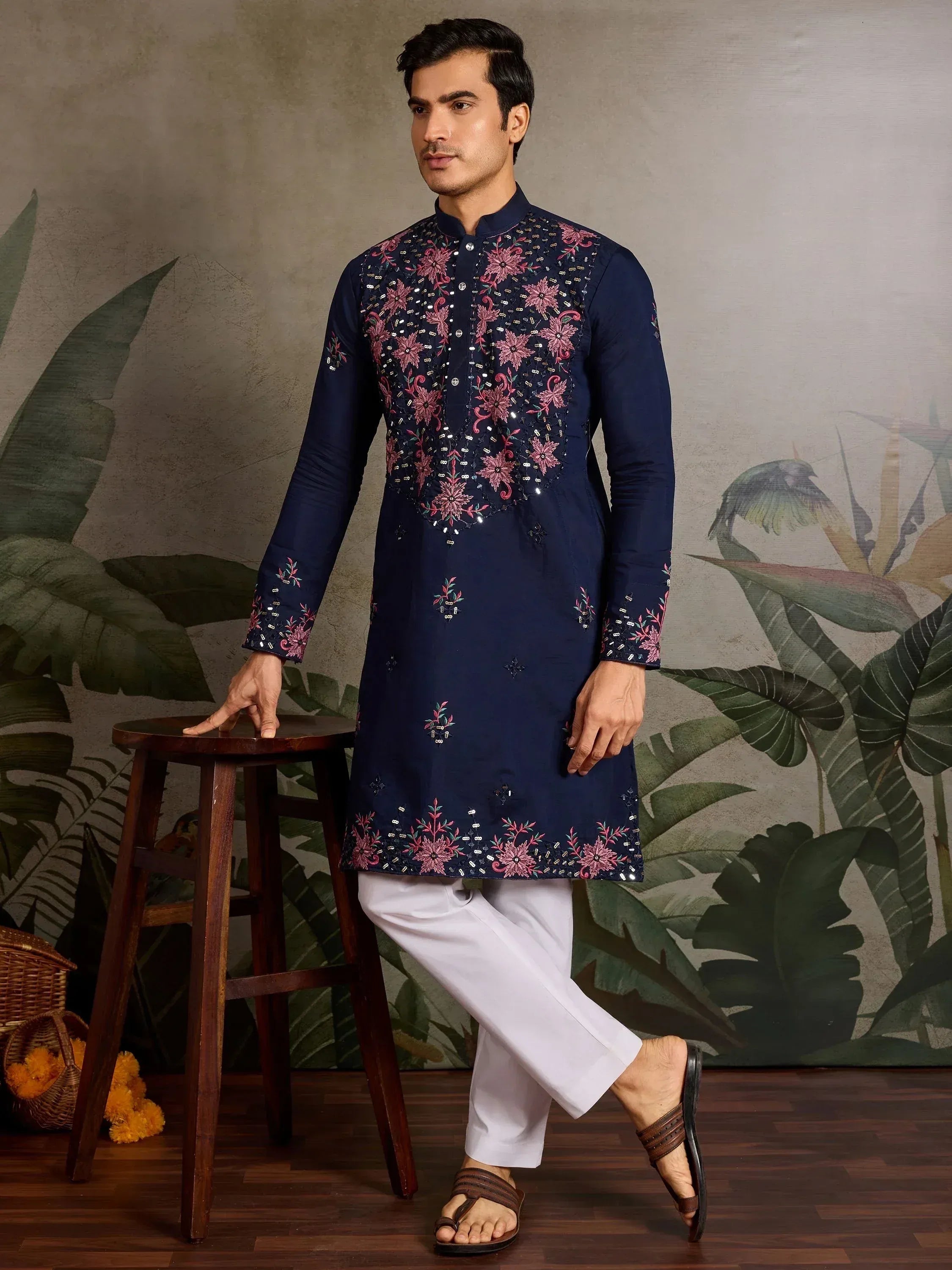 Navy blue embroidered kurta with pink floral motifs, paired with white pants for men's ethnic wear