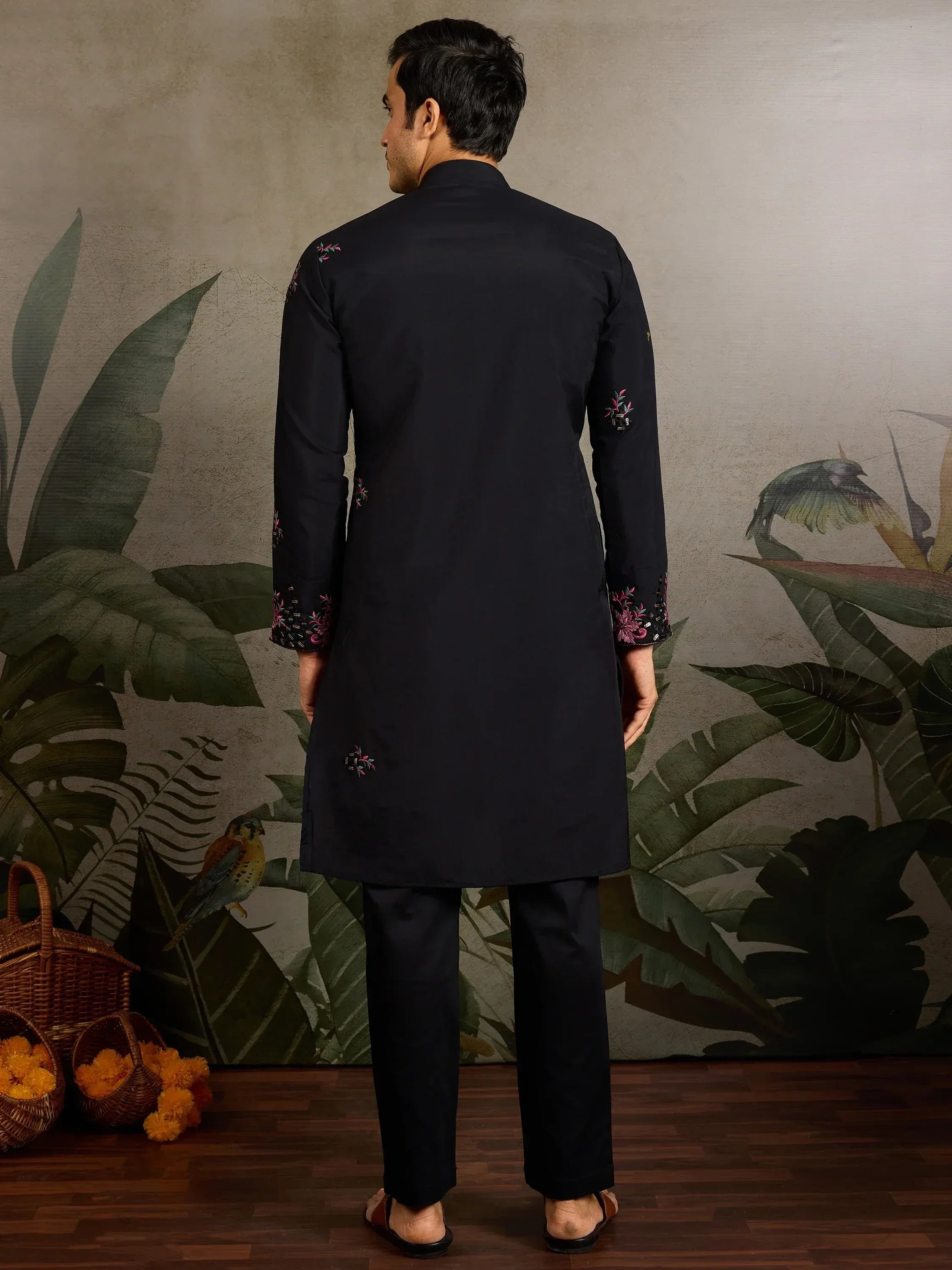 Black embroidered kurta set for men, featuring floral detailing on sleeves and back, ideal for ethnic occasions.