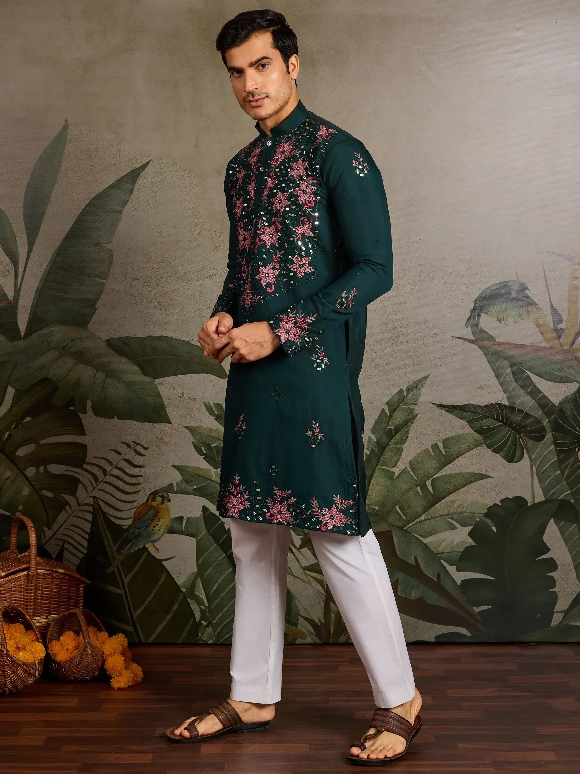 Men's green embroidered kurta with floral design, paired with white pants for ethnic wear