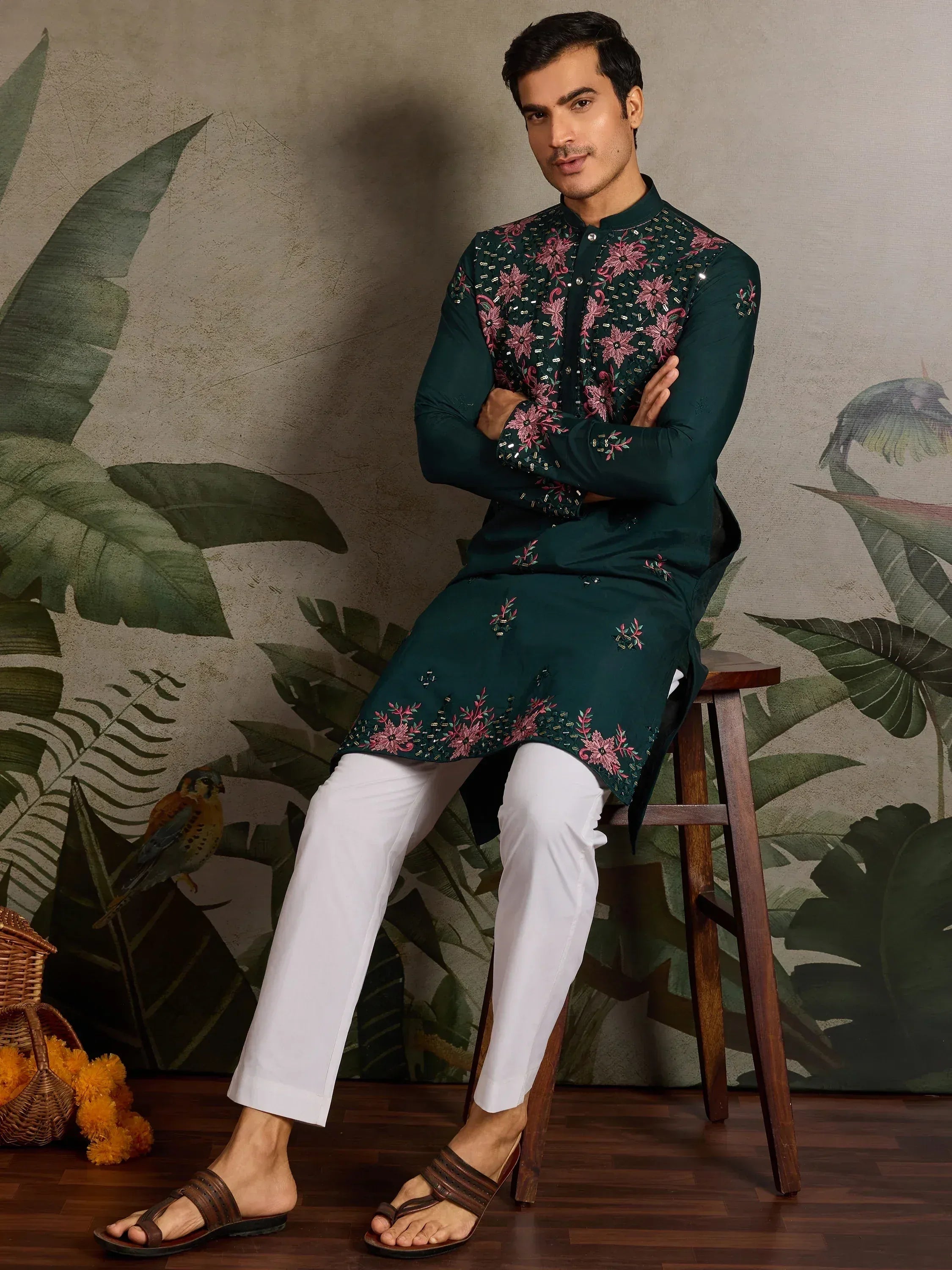 Man in emerald green embroidered kurta with white pants, floral design, ethnic wear