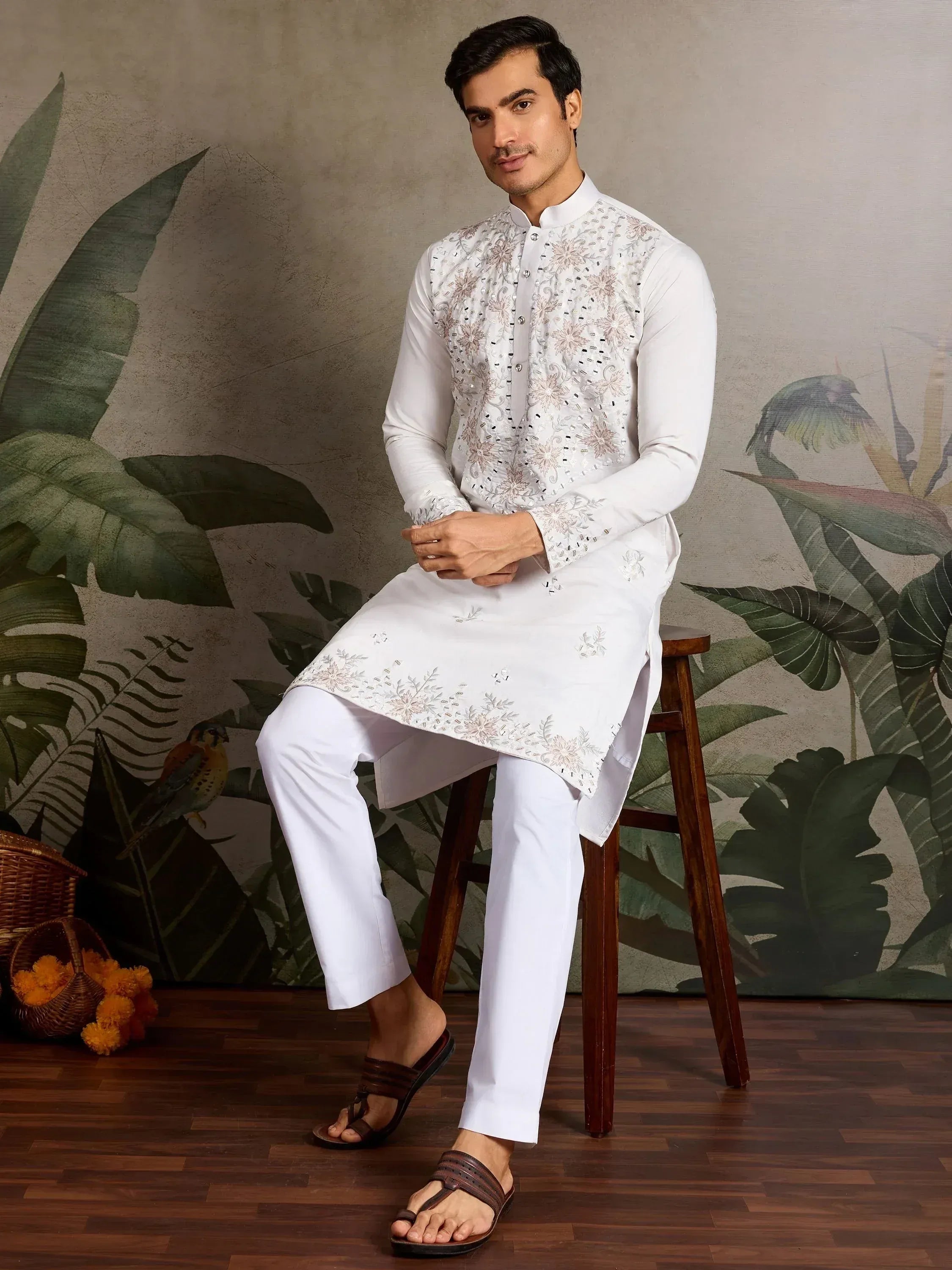 Man in white embroidered kurta set with floral design, perfect for Indian ethnic wear occasions