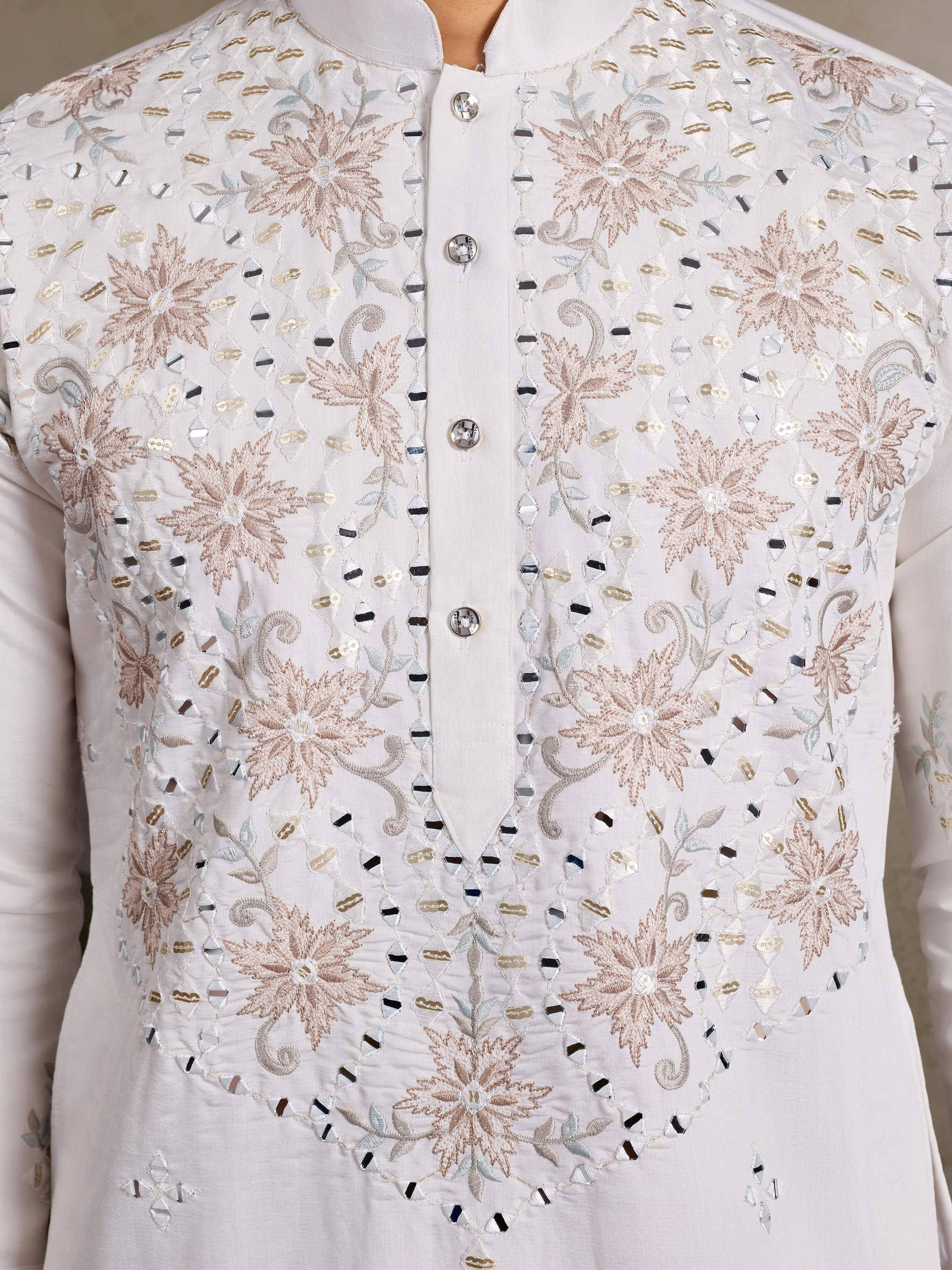 White ethnic kurta with floral embroidery and mirror work, perfect for Indian festive wear