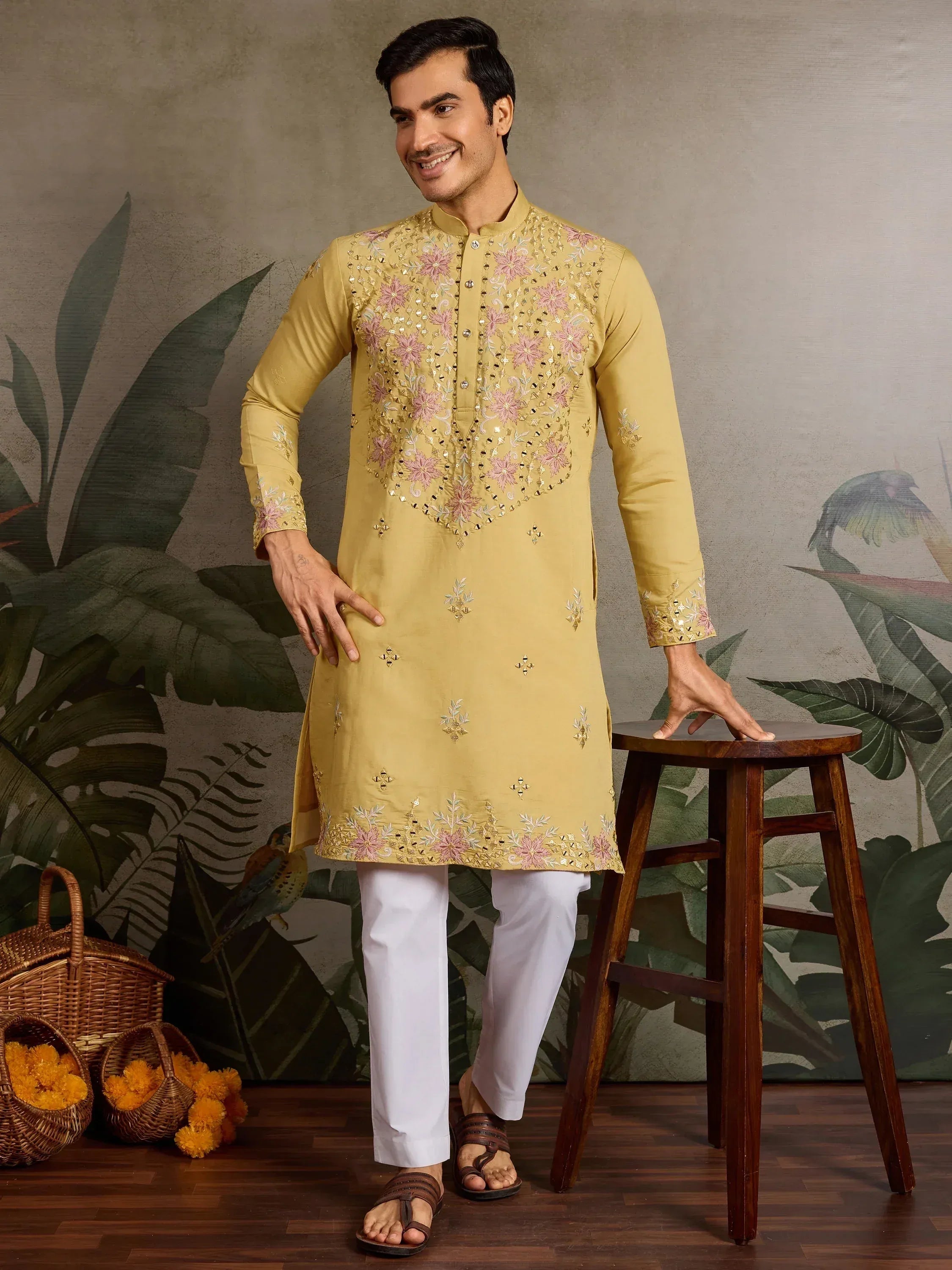 Men's mustard yellow kurta with pink floral embroidery, paired with white pants for ethnic wear