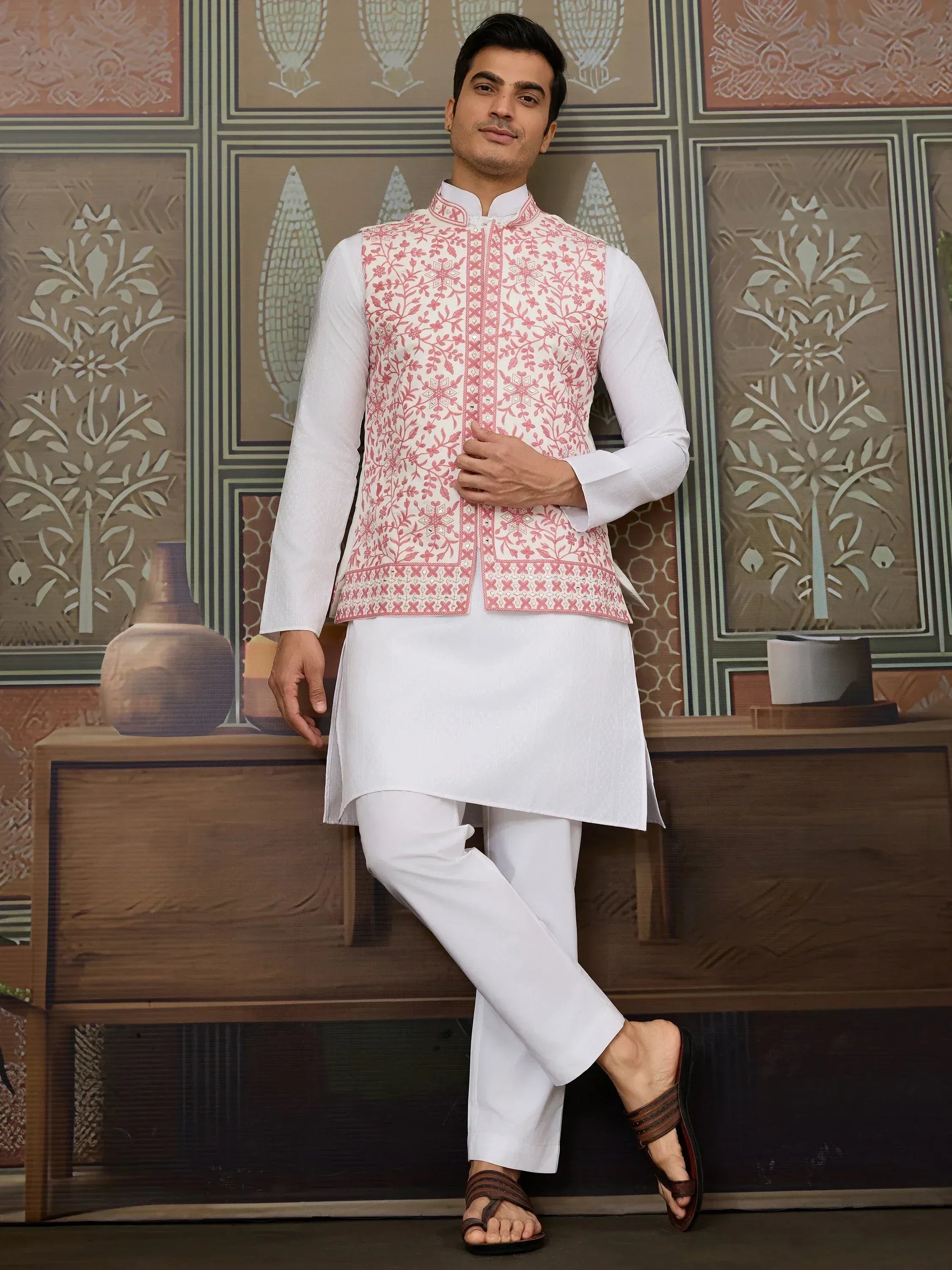 Men's white kurta set with pink floral embroidered waistcoat, ideal for Indian ethnic occasions
