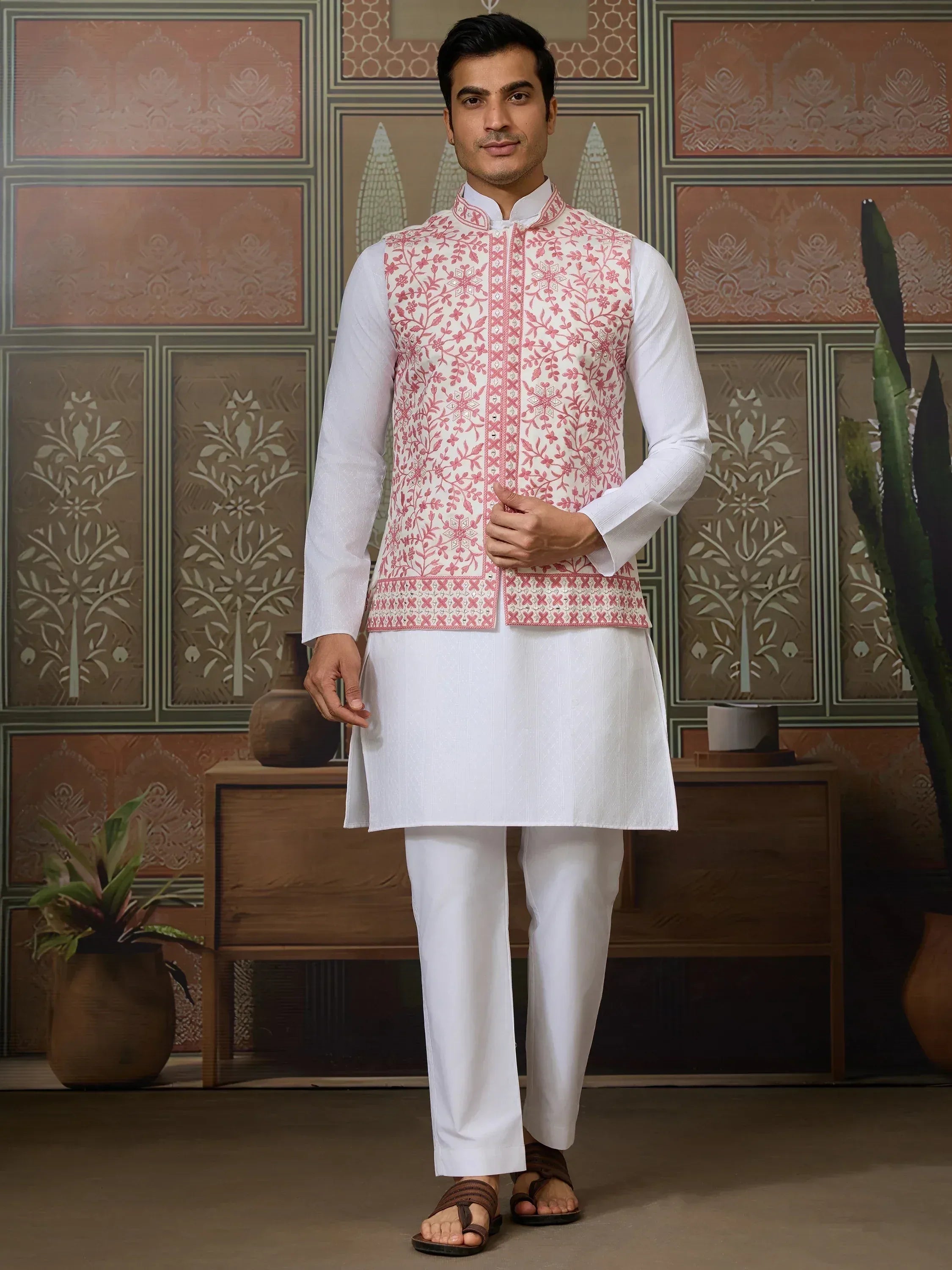 Man in white kurta pajama with pink floral embroidered waistcoat, Indian ethnic wear