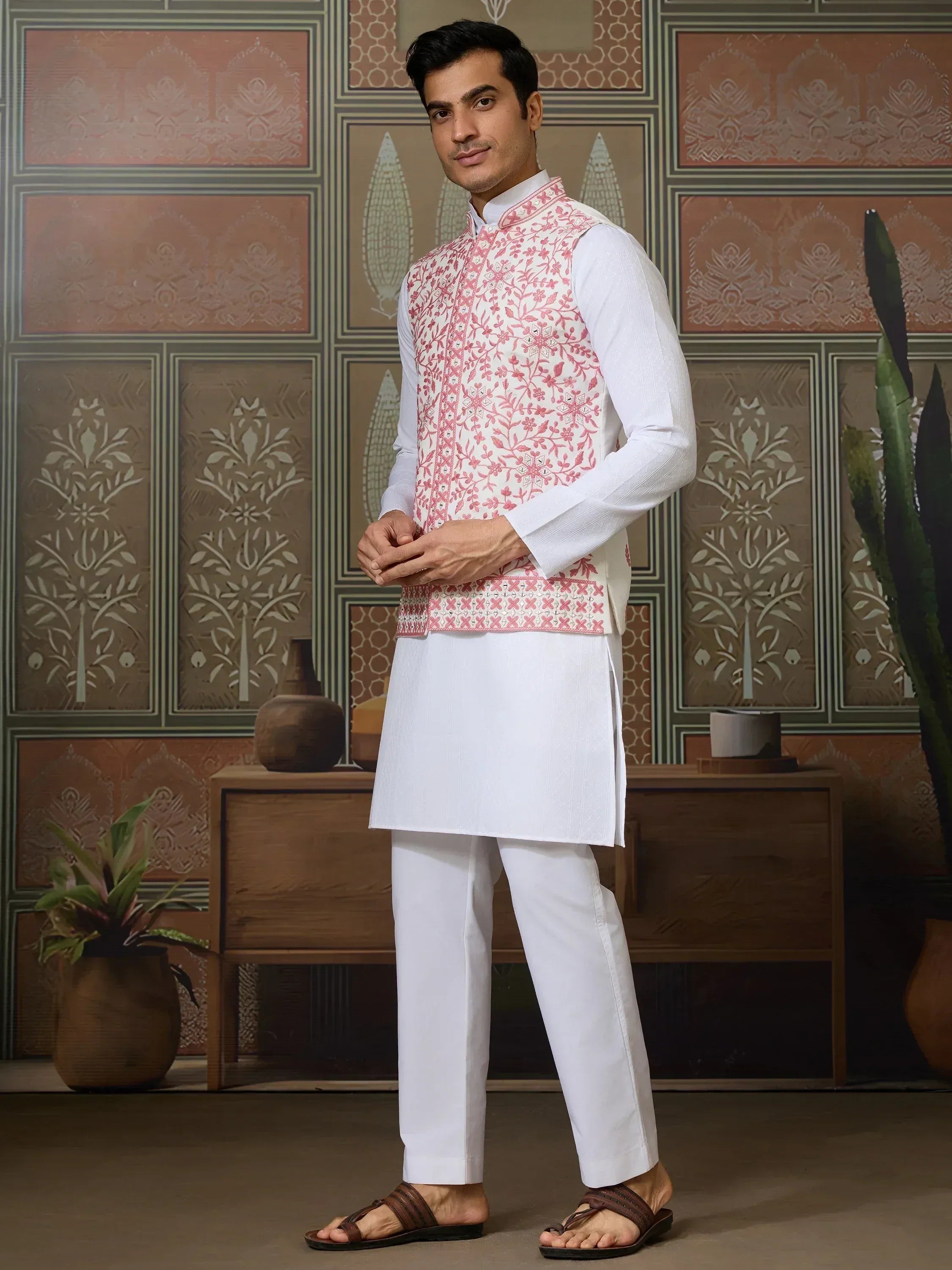 Man in white kurta pajama with pink floral embroidered waistcoat, ethnic Indian wear