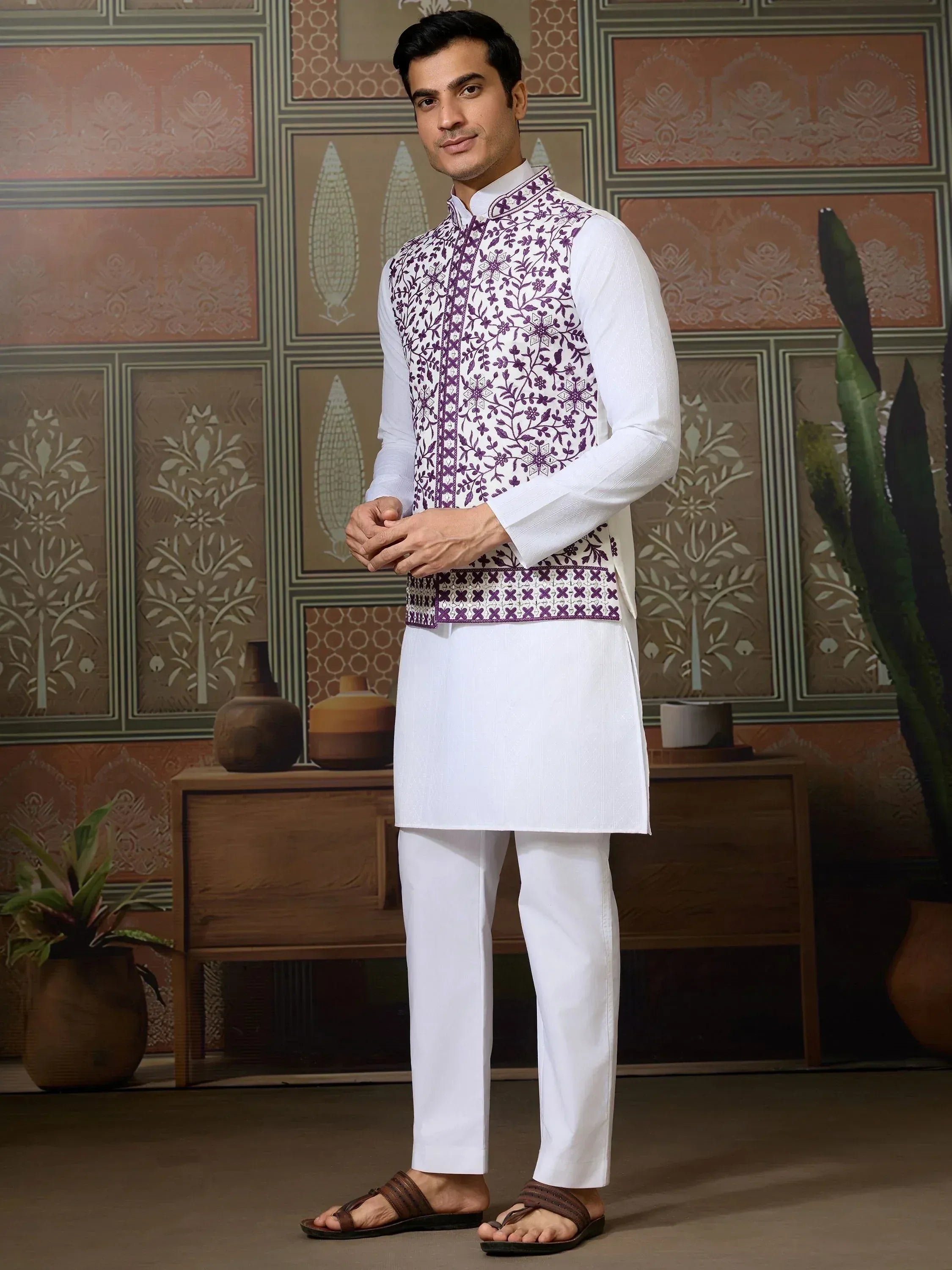 Man in white kurta pajama with purple floral embroidered vest, Indian ethnic wear
