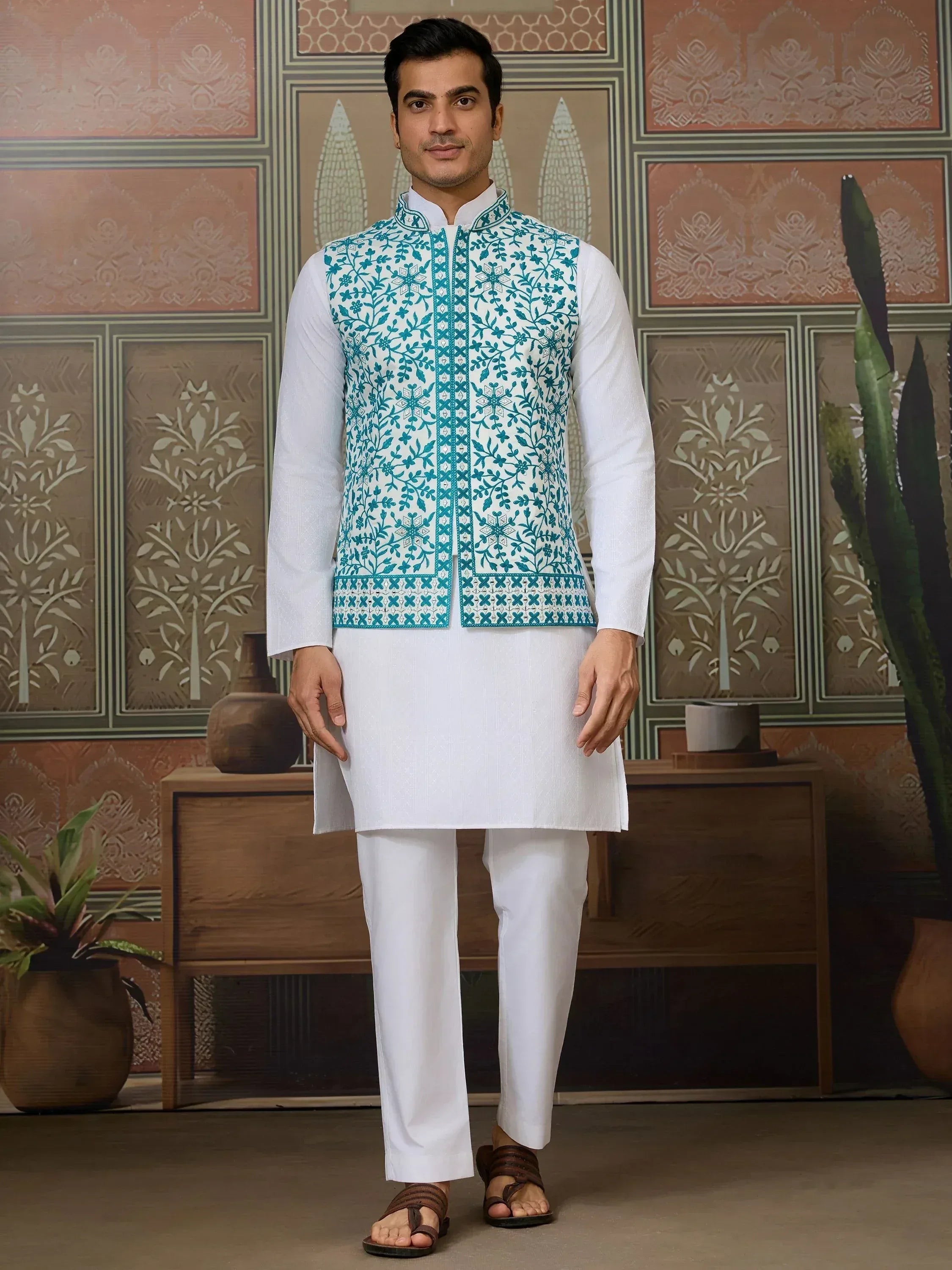 Man in white kurta pajama with teal embroidered Nehru jacket, Indian ethnic wear