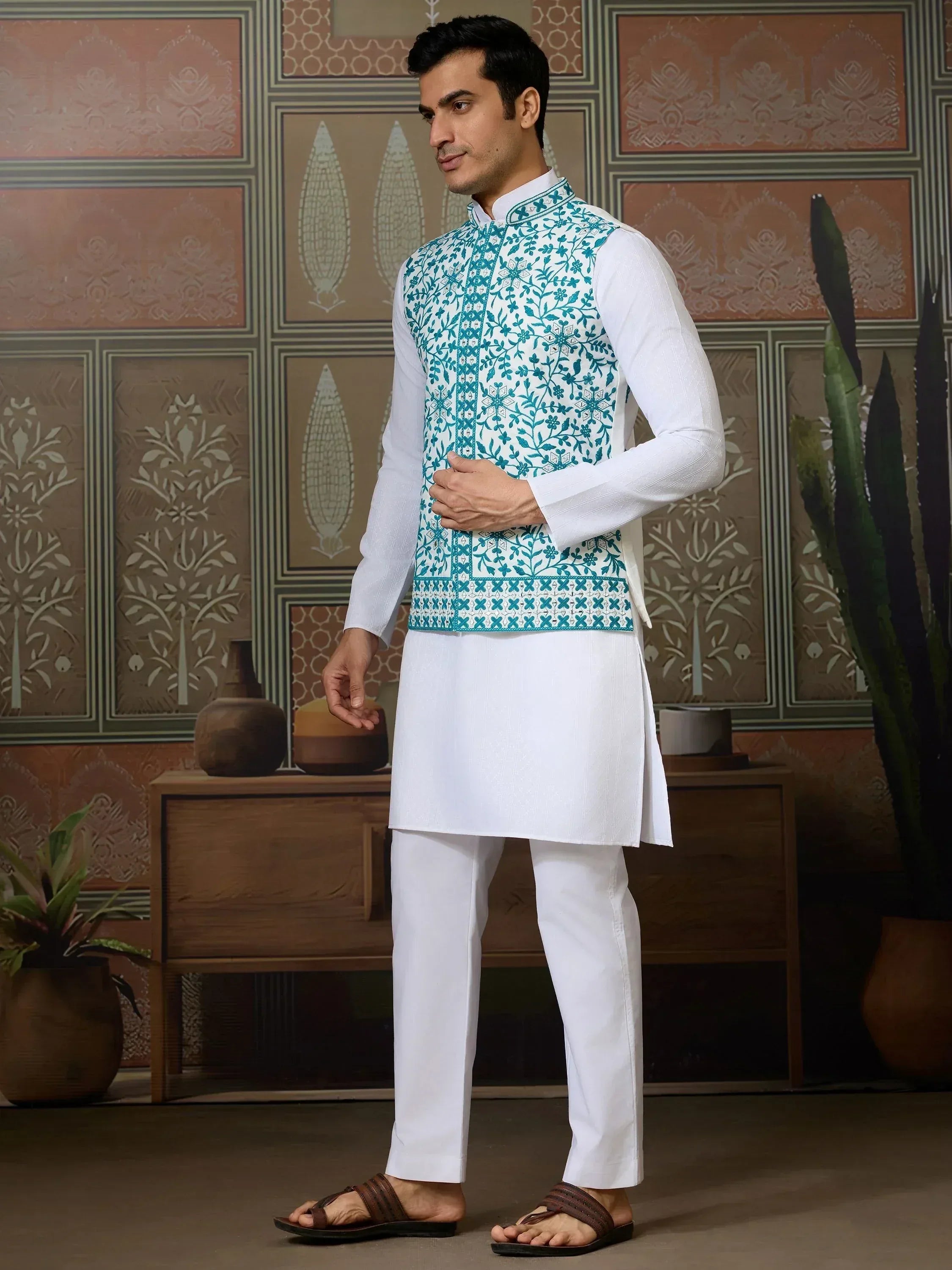 Man in white kurta pajama with teal embroidered Nehru jacket, Indian ethnic wear