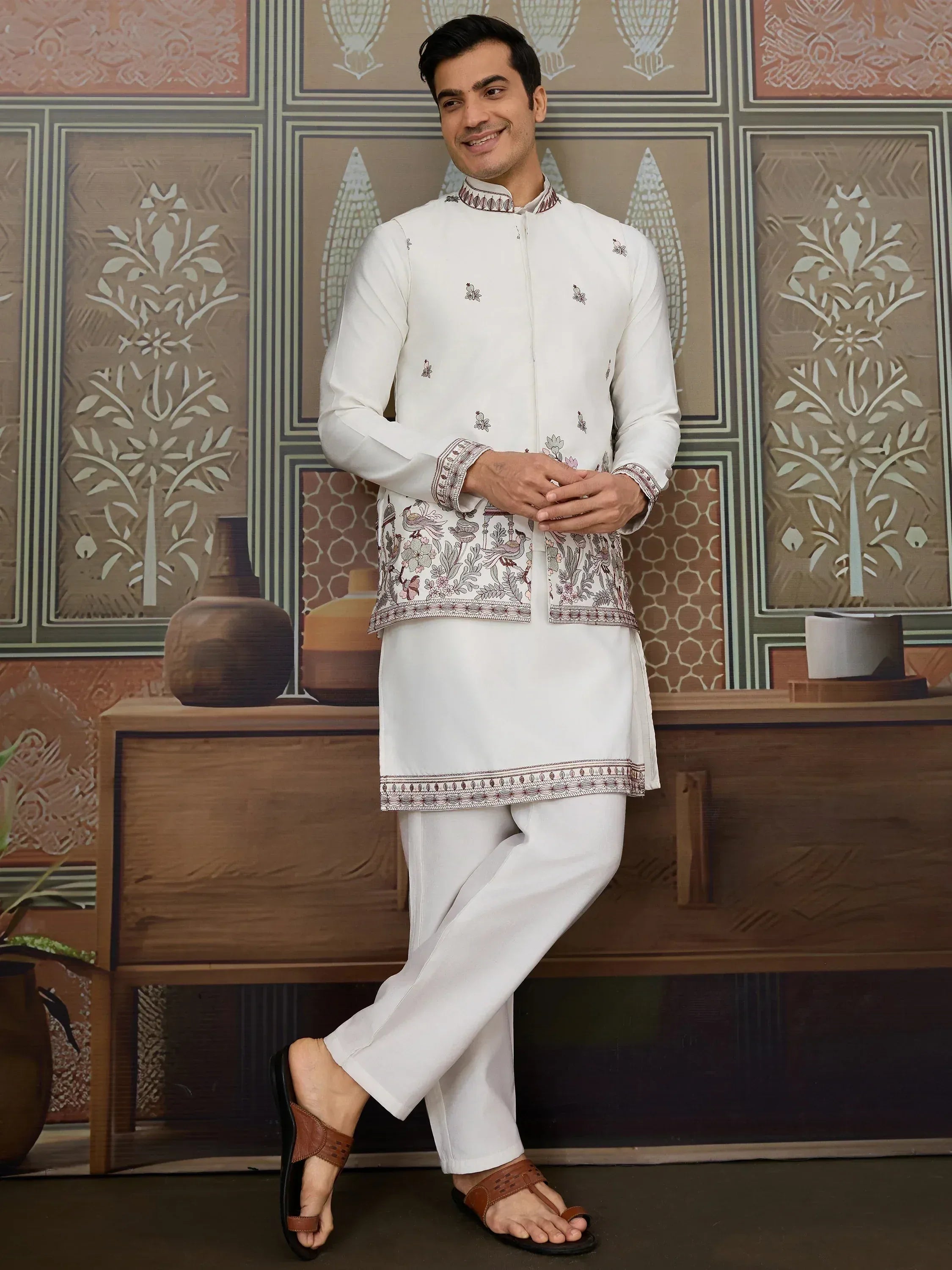 Man in white embroidered kurta set with floral patterns, ethnic Indian wear for men