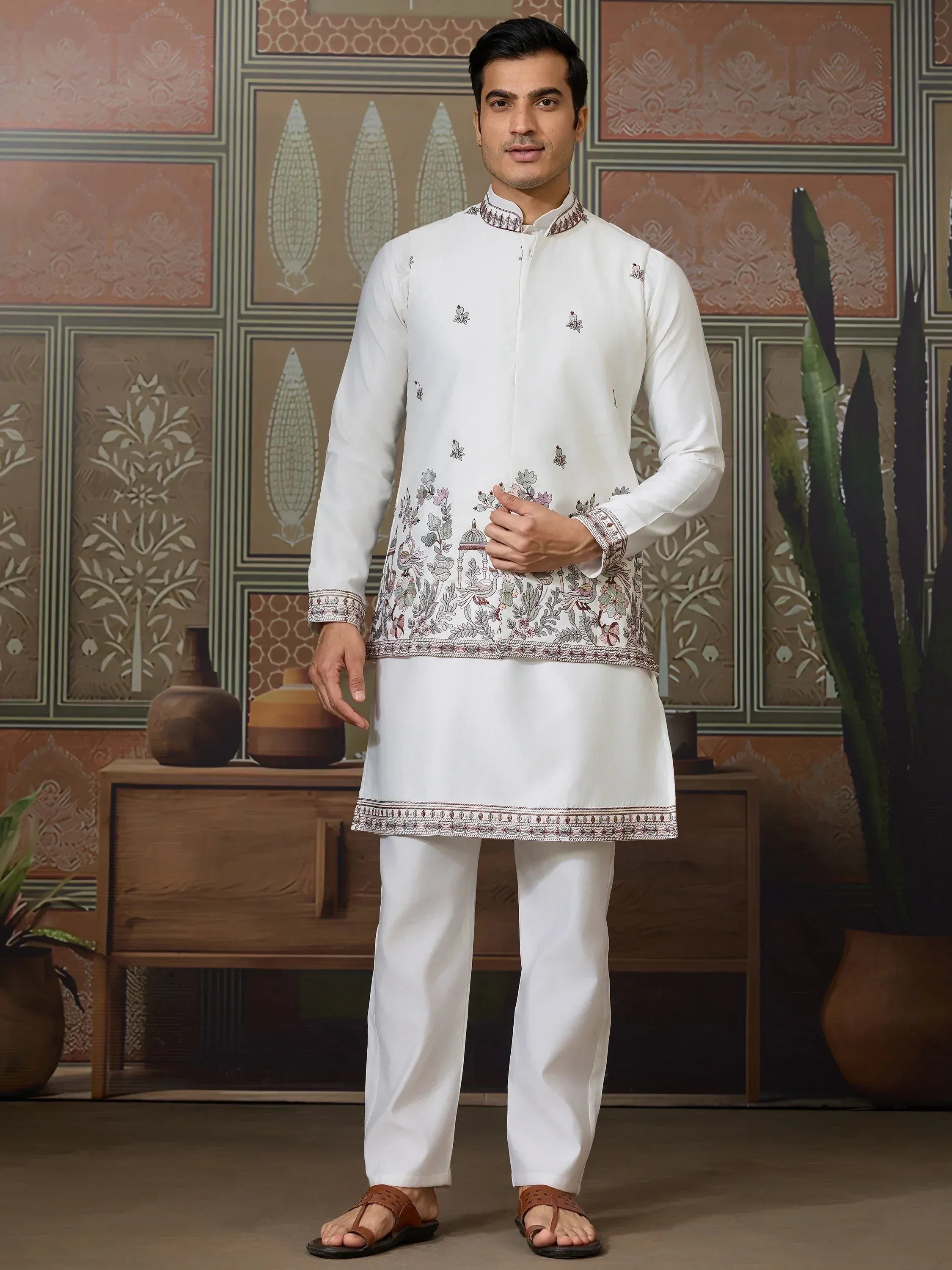 White embroidered kurta set with floral and temple motifs, ideal for Indian ethnic wear occasions.