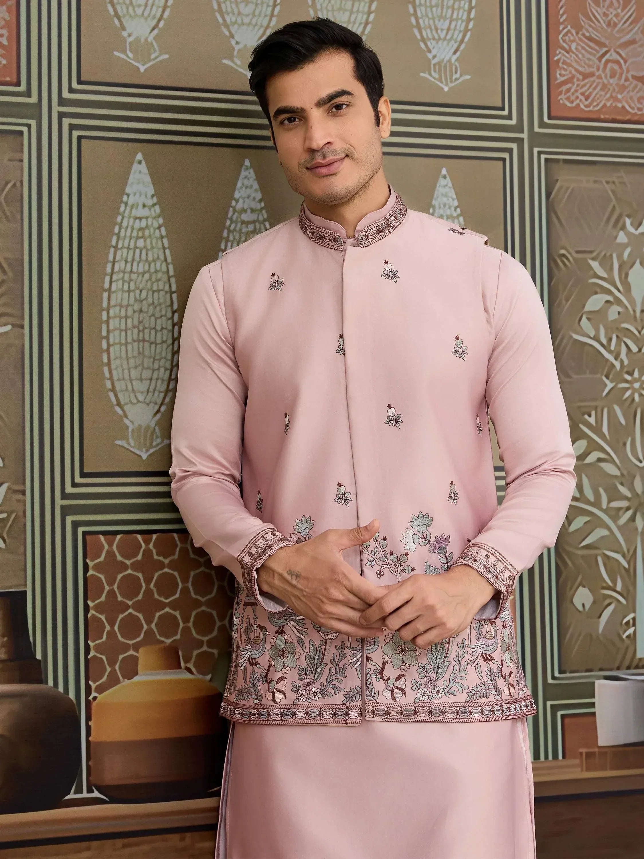 Man in pink embroidered kurta with floral and bird motifs, traditional Indian ethnic wear