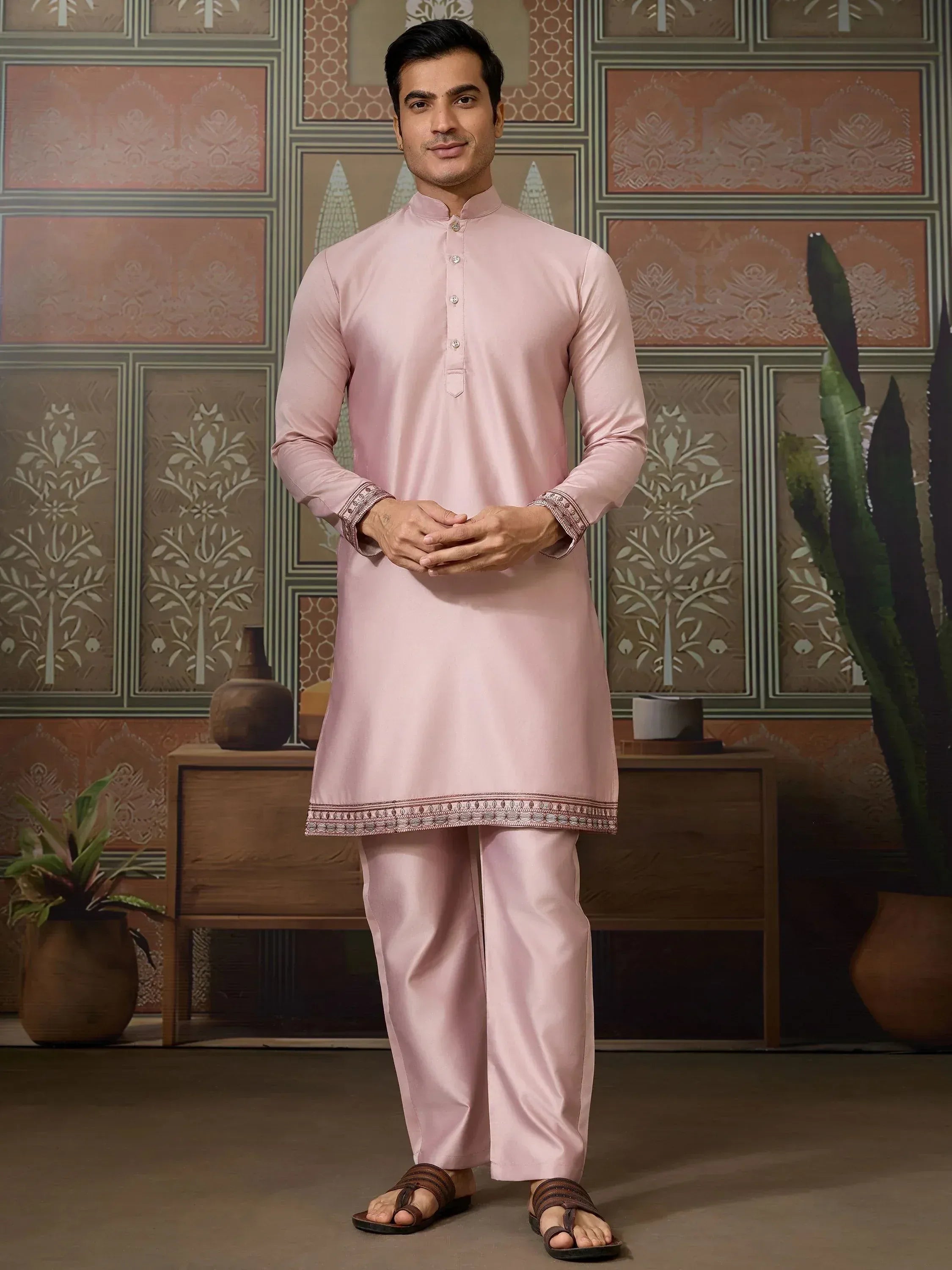 Men's pink kurta pajama set with embroidered hem and cuffs, ideal for ethnic occasions