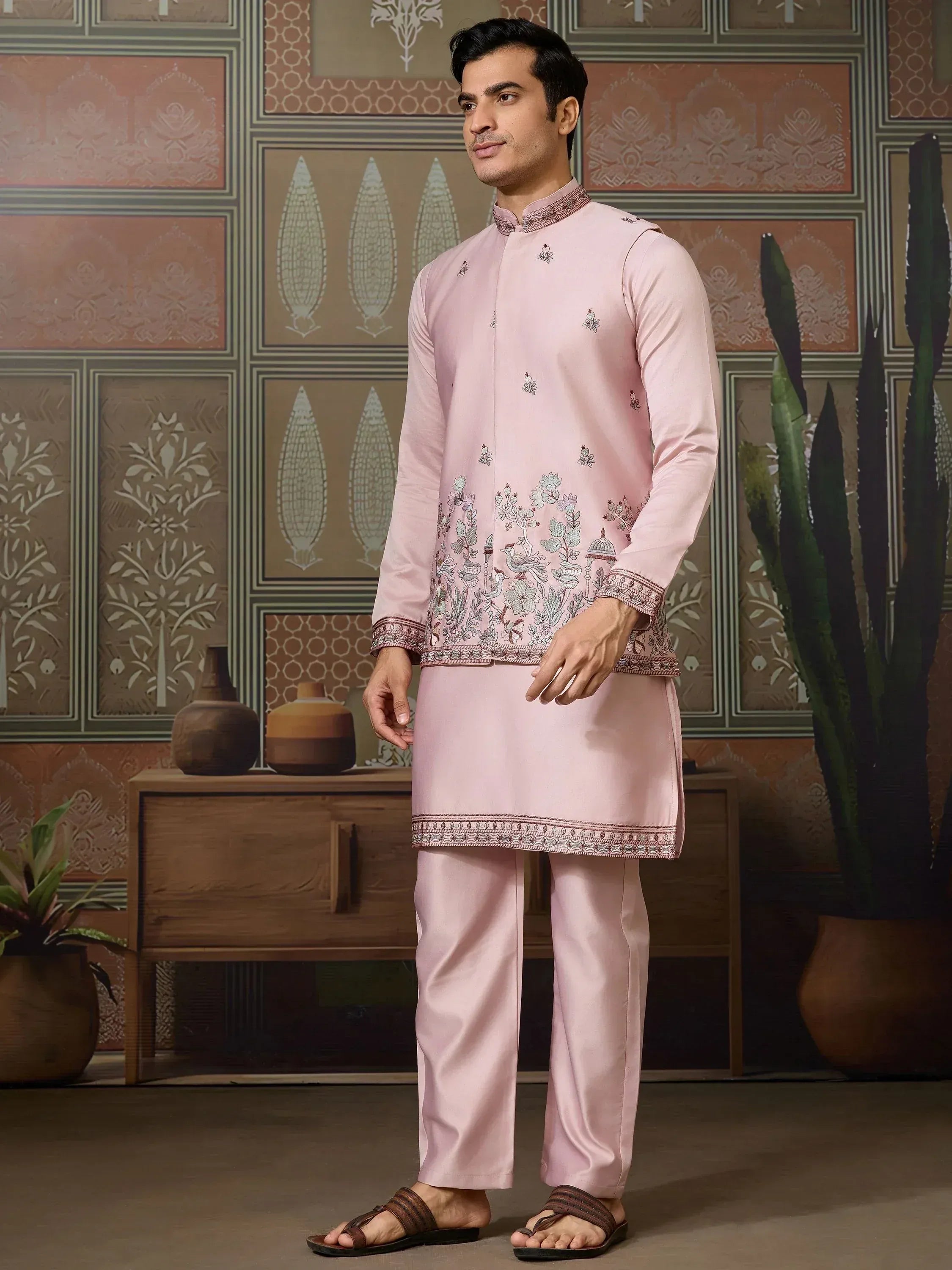Man in pink embroidered kurta set with floral and bird motifs, traditional Indian ethnic wear