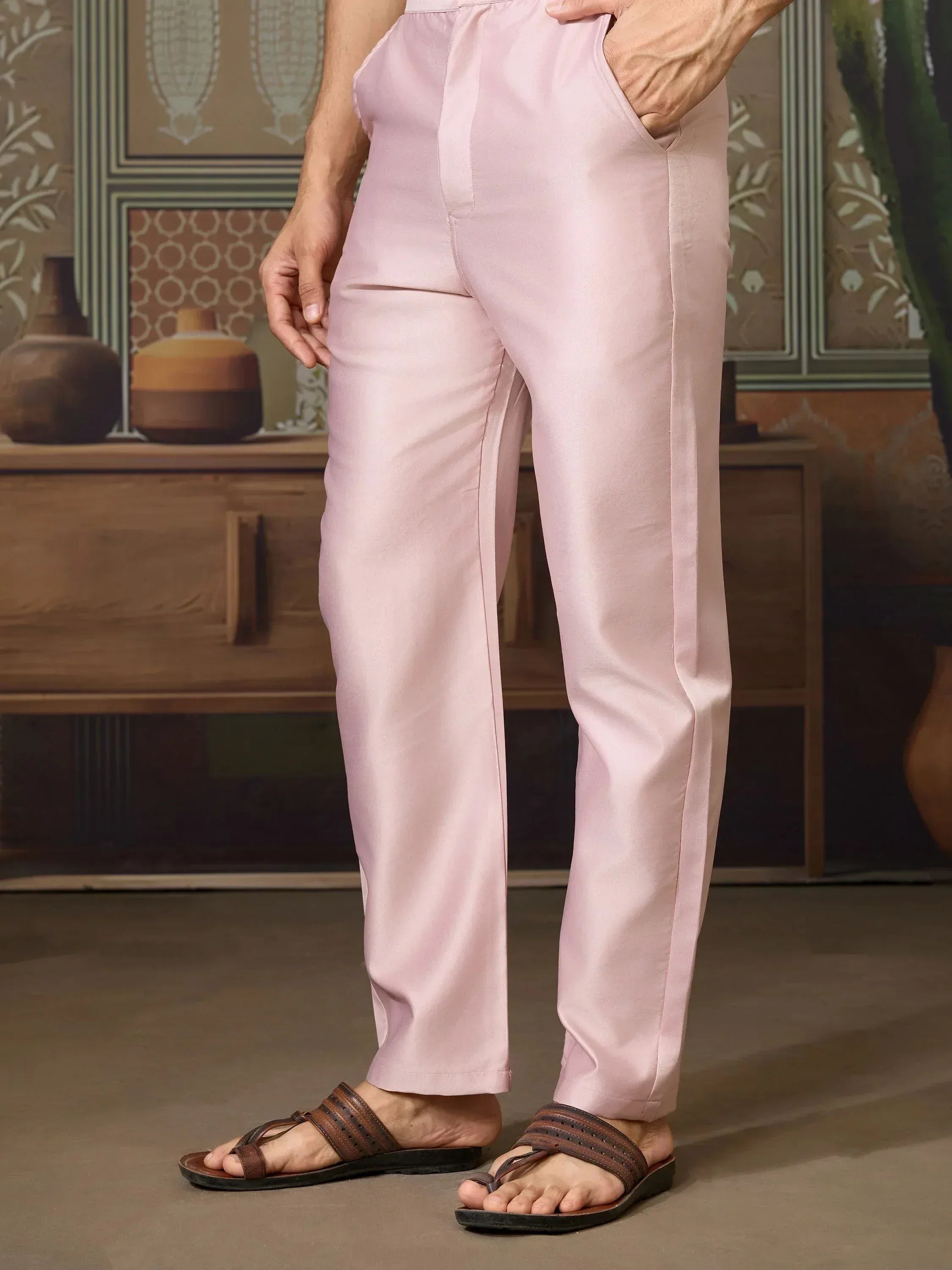 Men's light pink ethnic trousers with side pockets, paired with brown sandals for traditional wear.