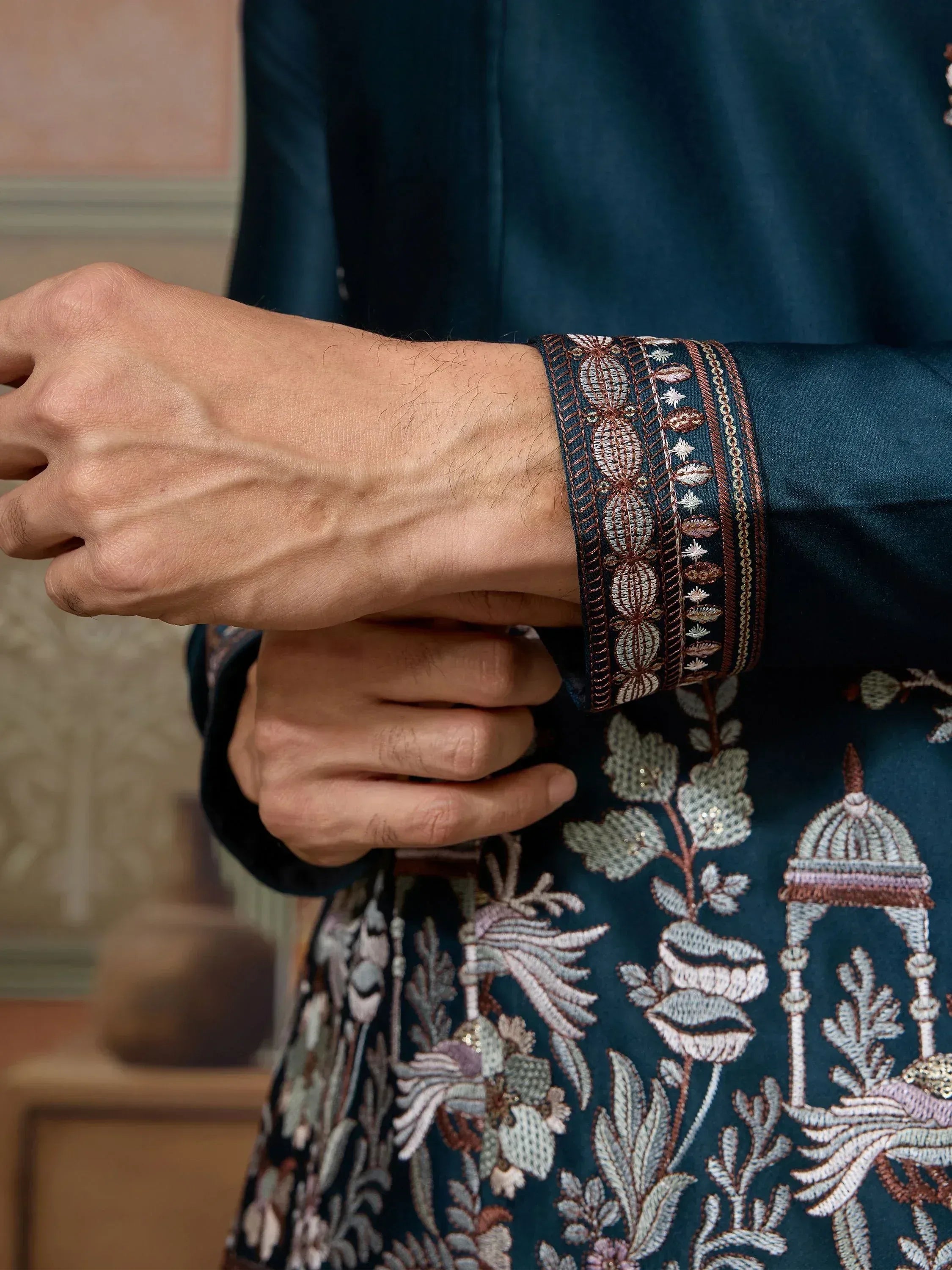 Men's ethnic kurta with intricate floral and dome embroidery, detailed cuff design