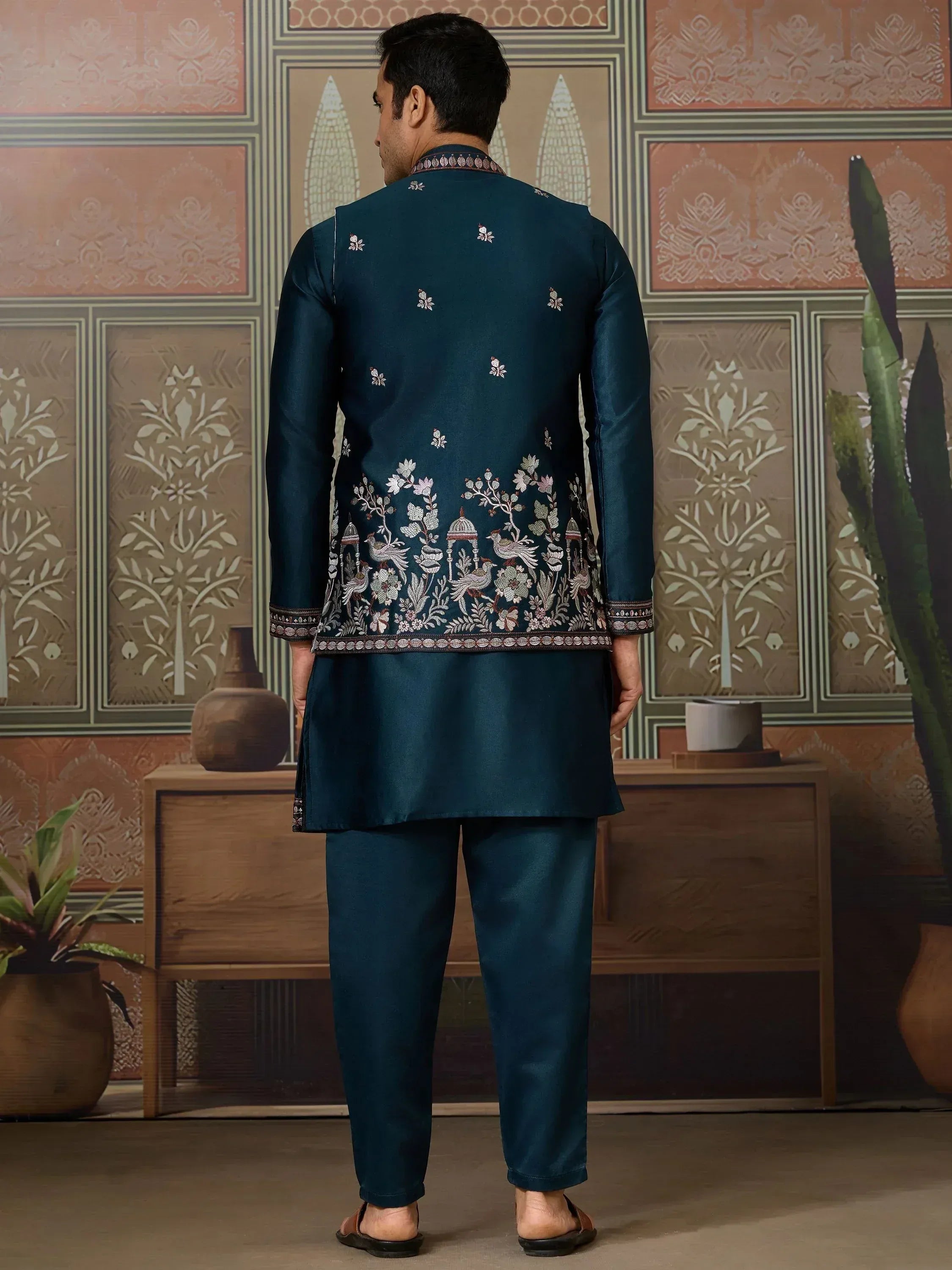 Men's teal embroidered kurta set with floral and bird motifs, ideal for Indian ethnic occasions