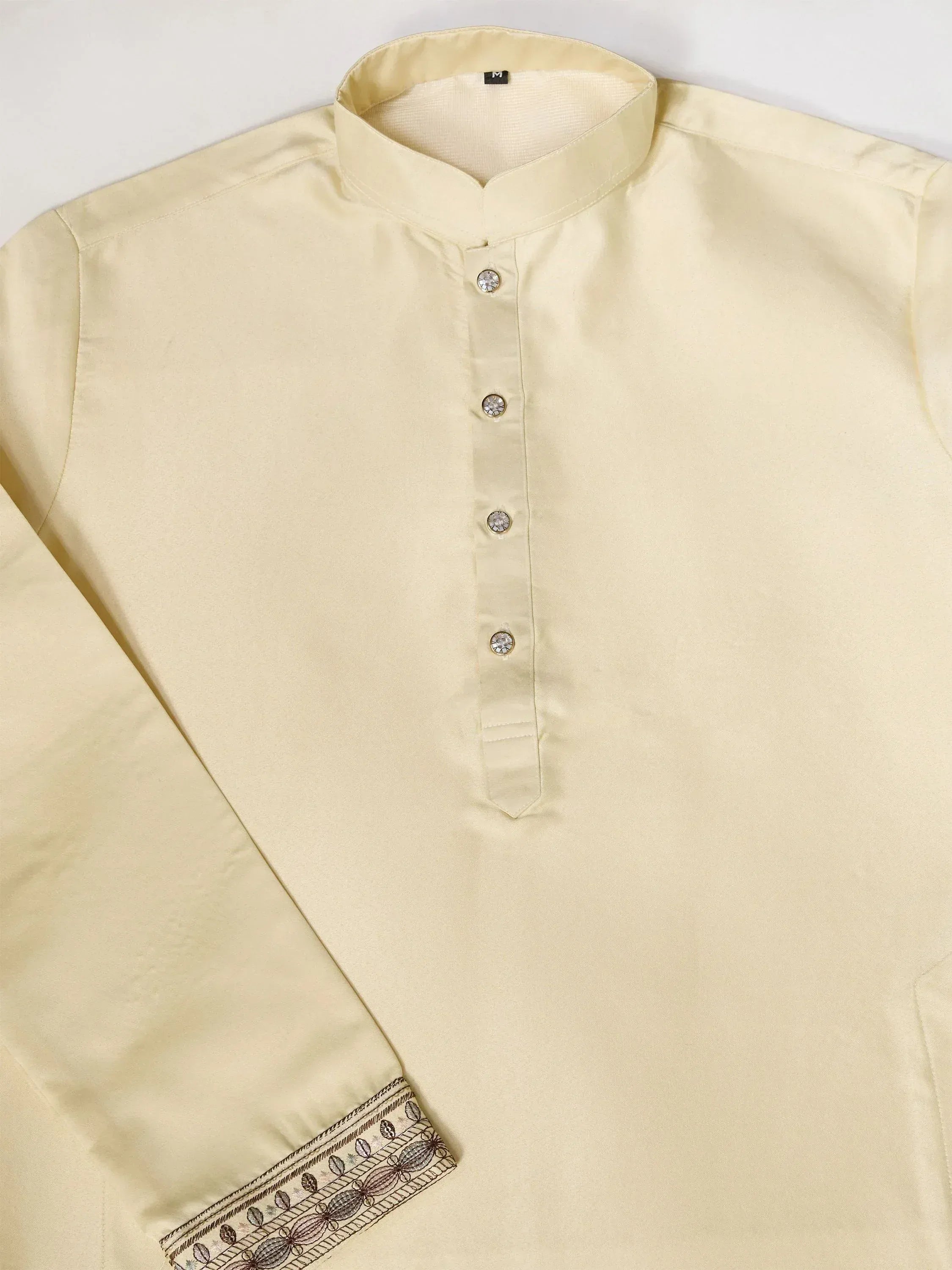 Cream ethnic kurta with embroidered cuffs and crystal buttons, ideal for Indian festive wear.