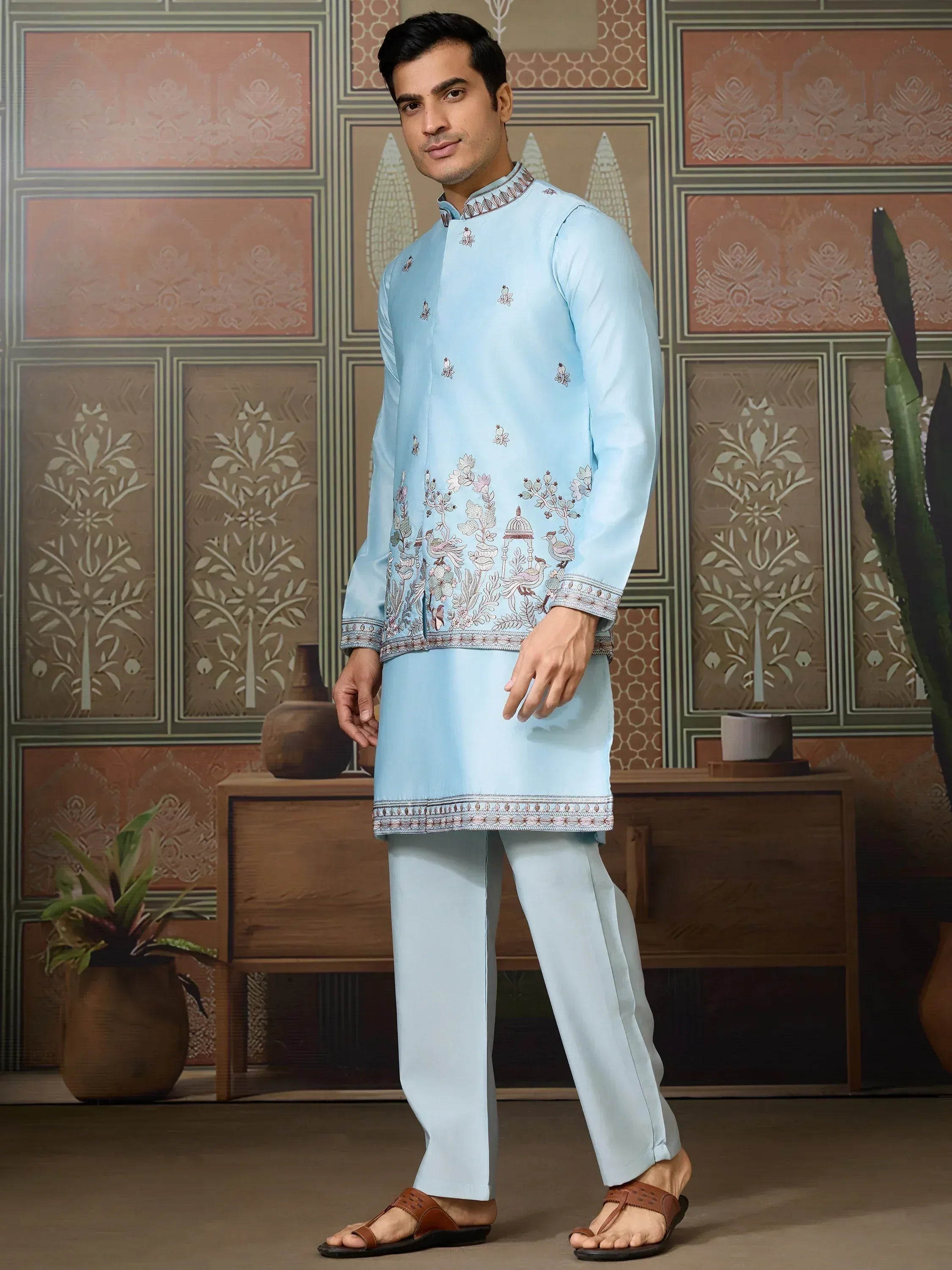 Light blue embroidered kurta pajama set for men, featuring floral and bird motifs, ideal for ethnic occasions.