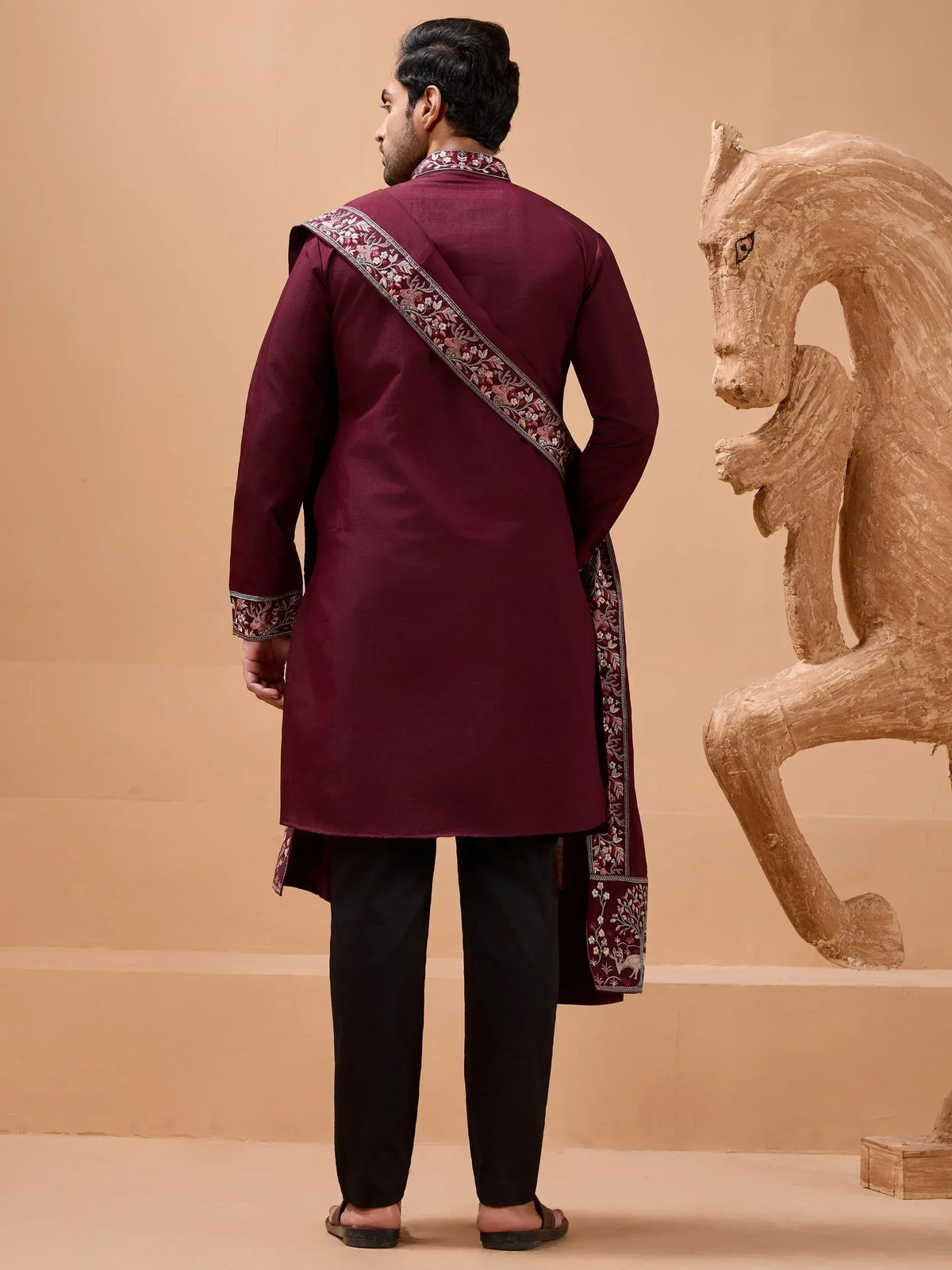 Maroon embroidered kurta with floral detailing, paired with black pants, showcasing traditional Indian ethnic wear.
