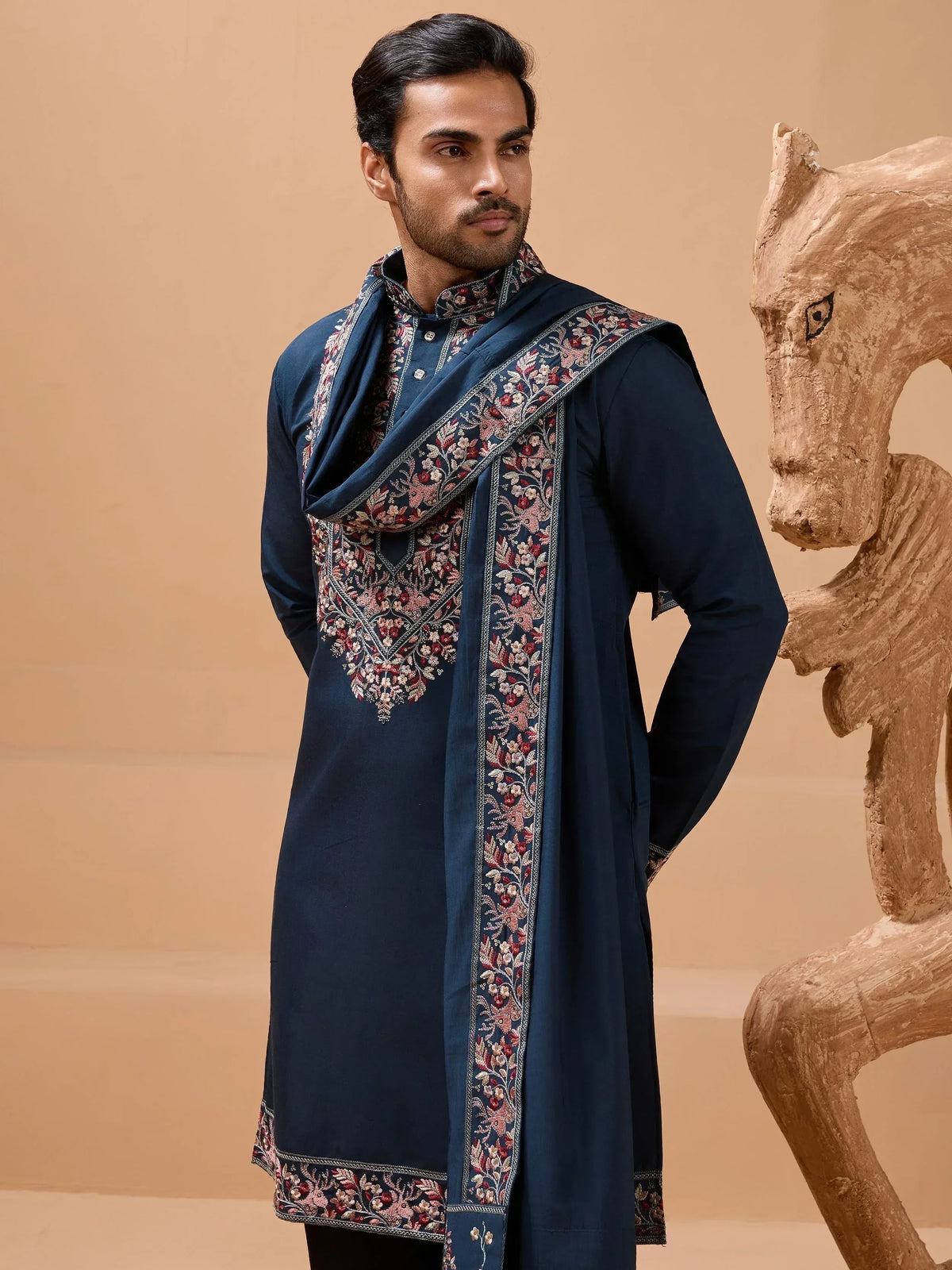 Man in navy blue embroidered kurta with floral dupatta, Indian ethnic wear