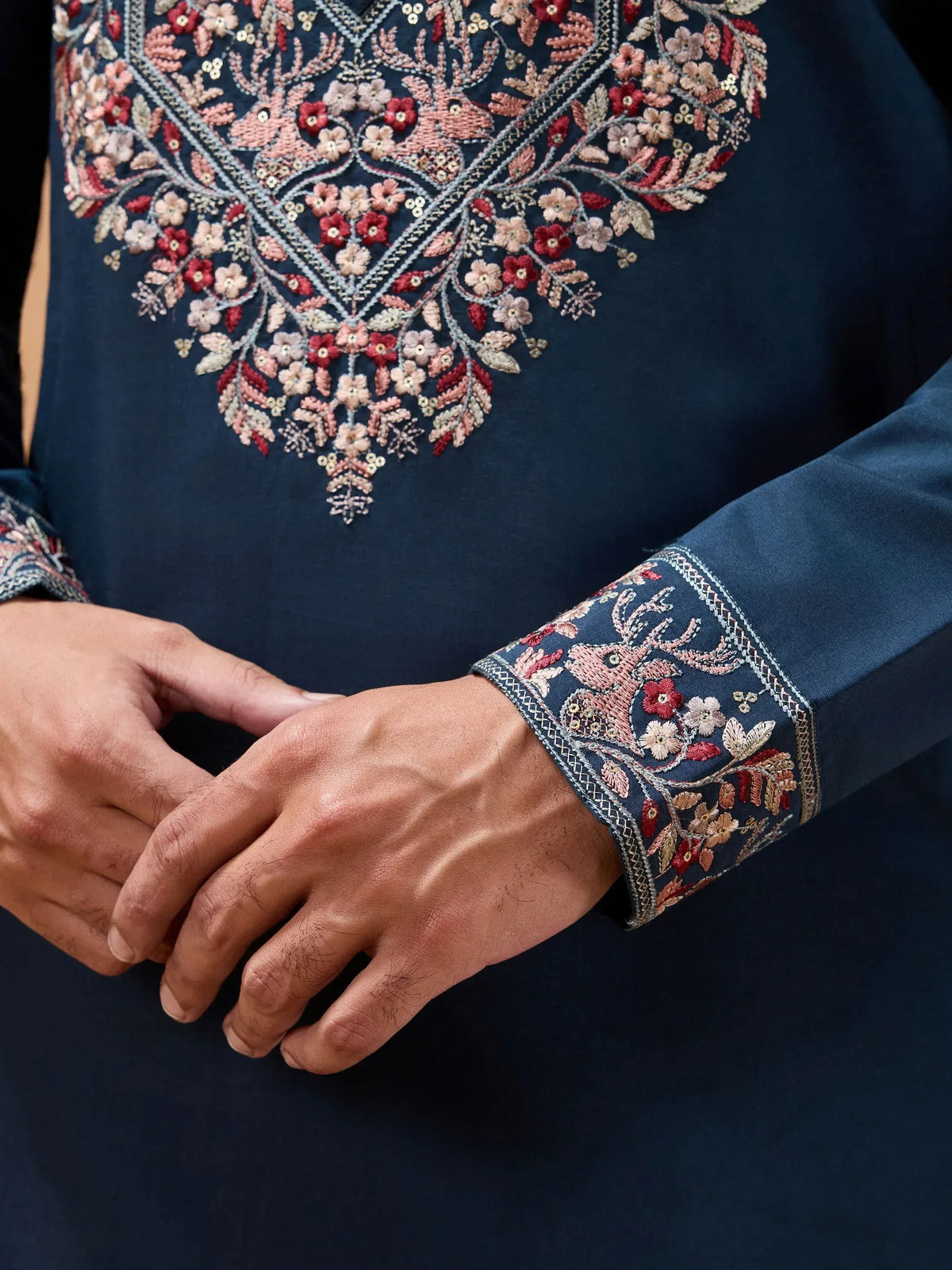 Navy blue ethnic kurta with intricate floral embroidery and deer motifs on chest and cuffs, perfect for festive occasions.