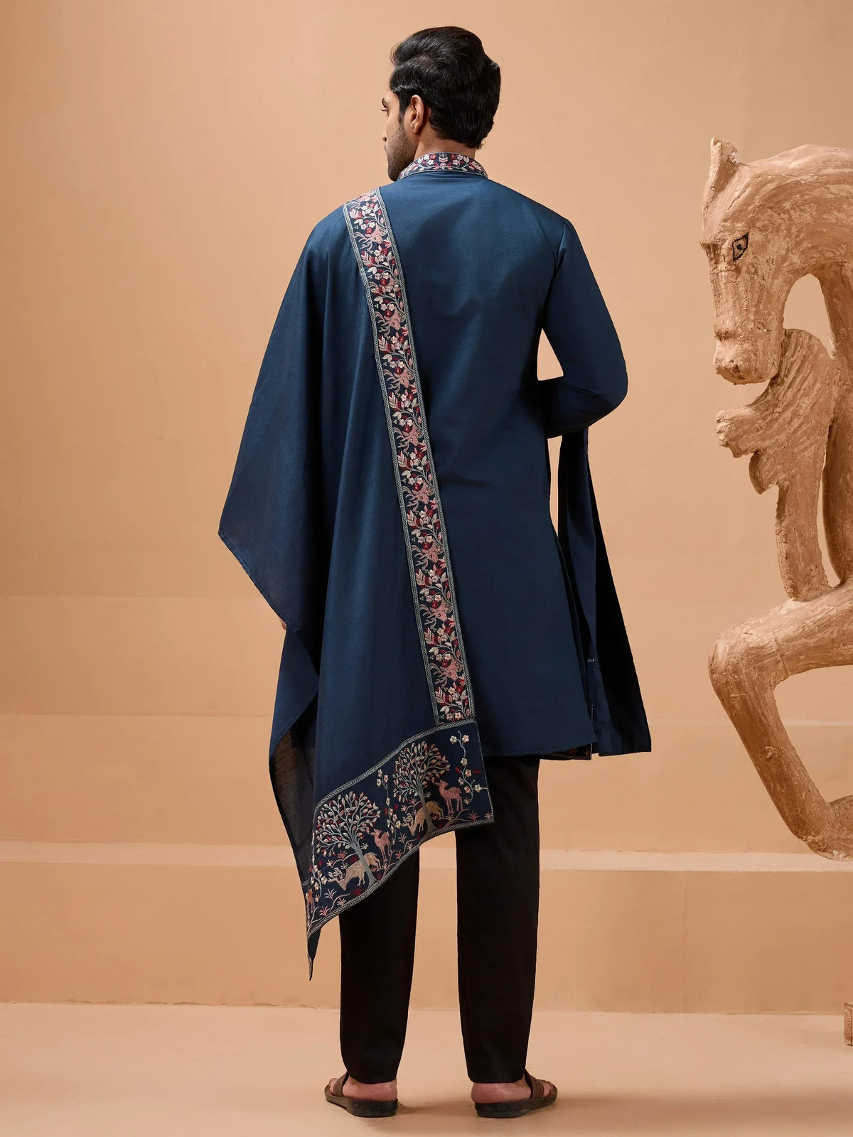 Navy blue embroidered kurta with floral and deer motifs, paired with black pants for ethnic wear.