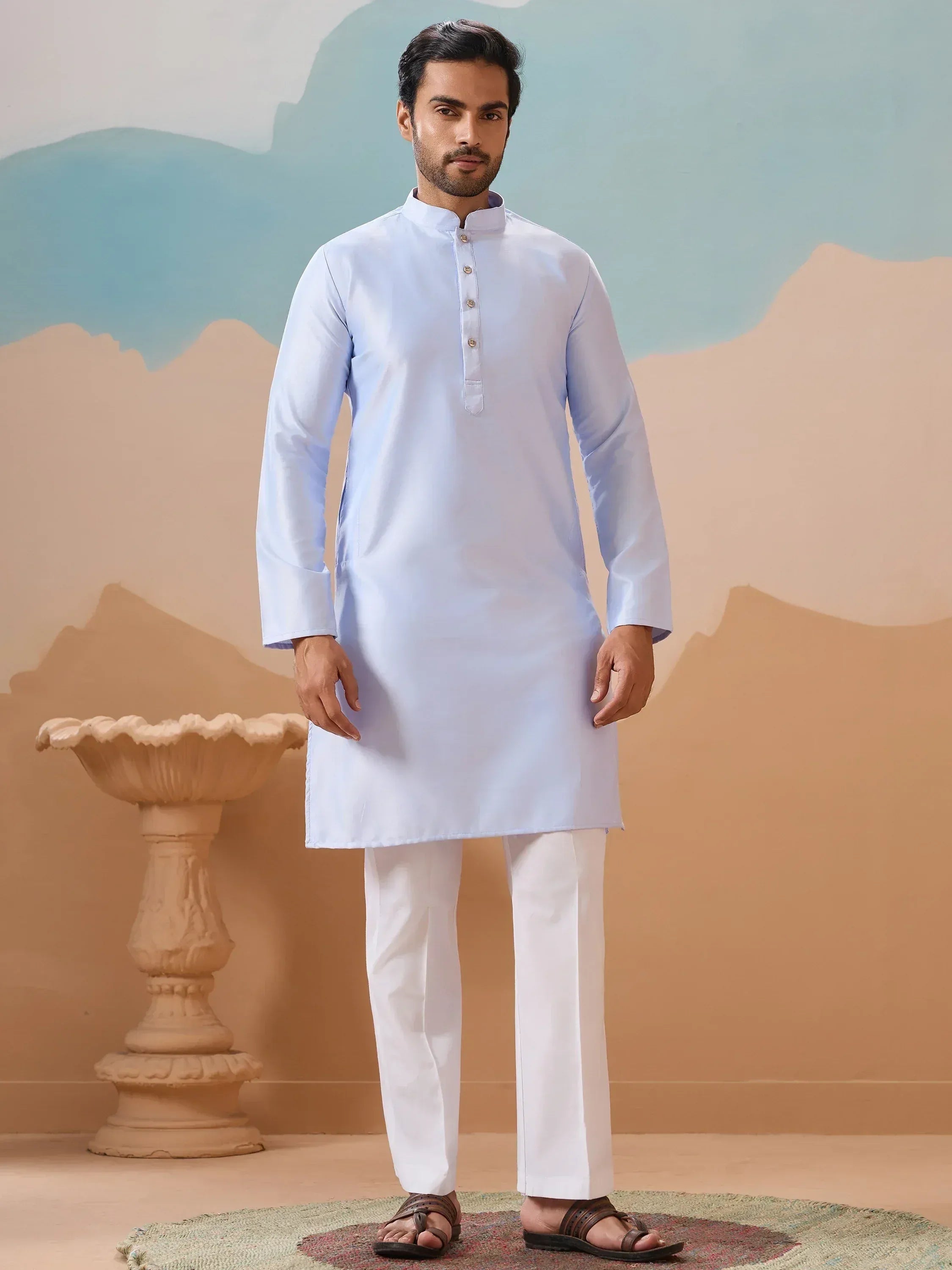 Man wearing light blue kurta with white pants, traditional Indian ethnic wear for men
