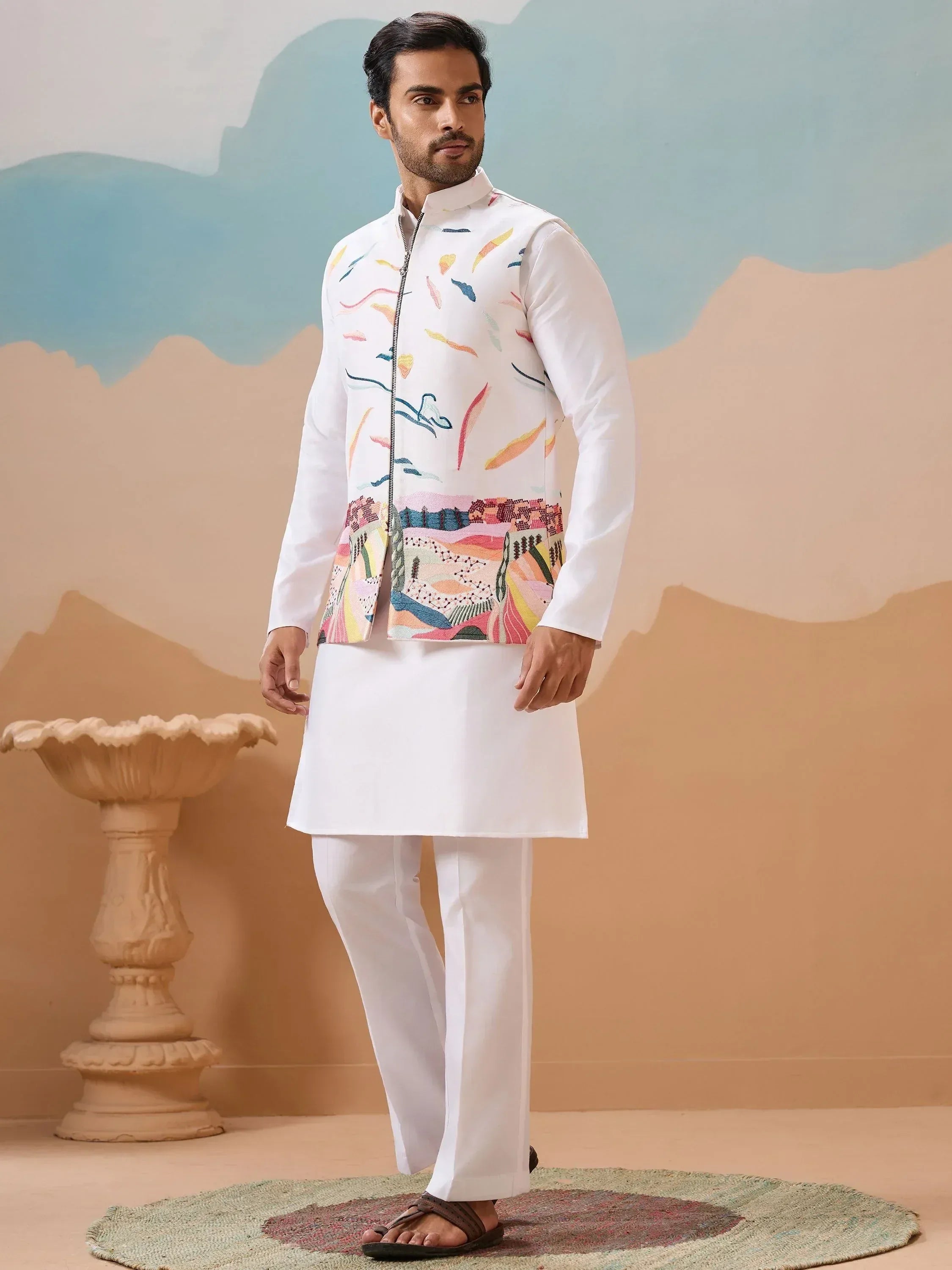 Man in white kurta pajama with colorful printed Nehru jacket, ethnic Indian wear