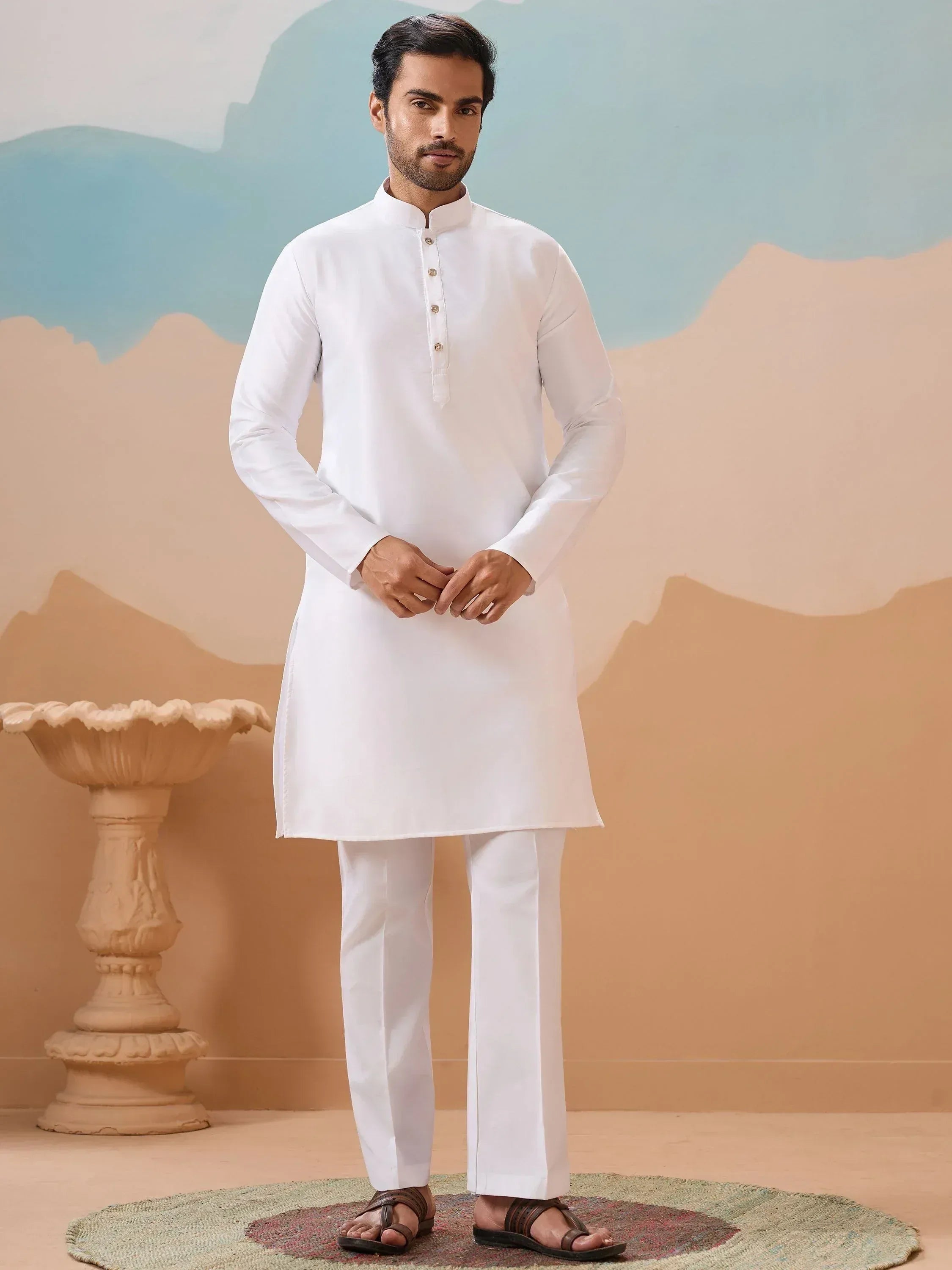 Man wearing white kurta pajama set, traditional Indian ethnic wear for men, perfect for festivals and occasions